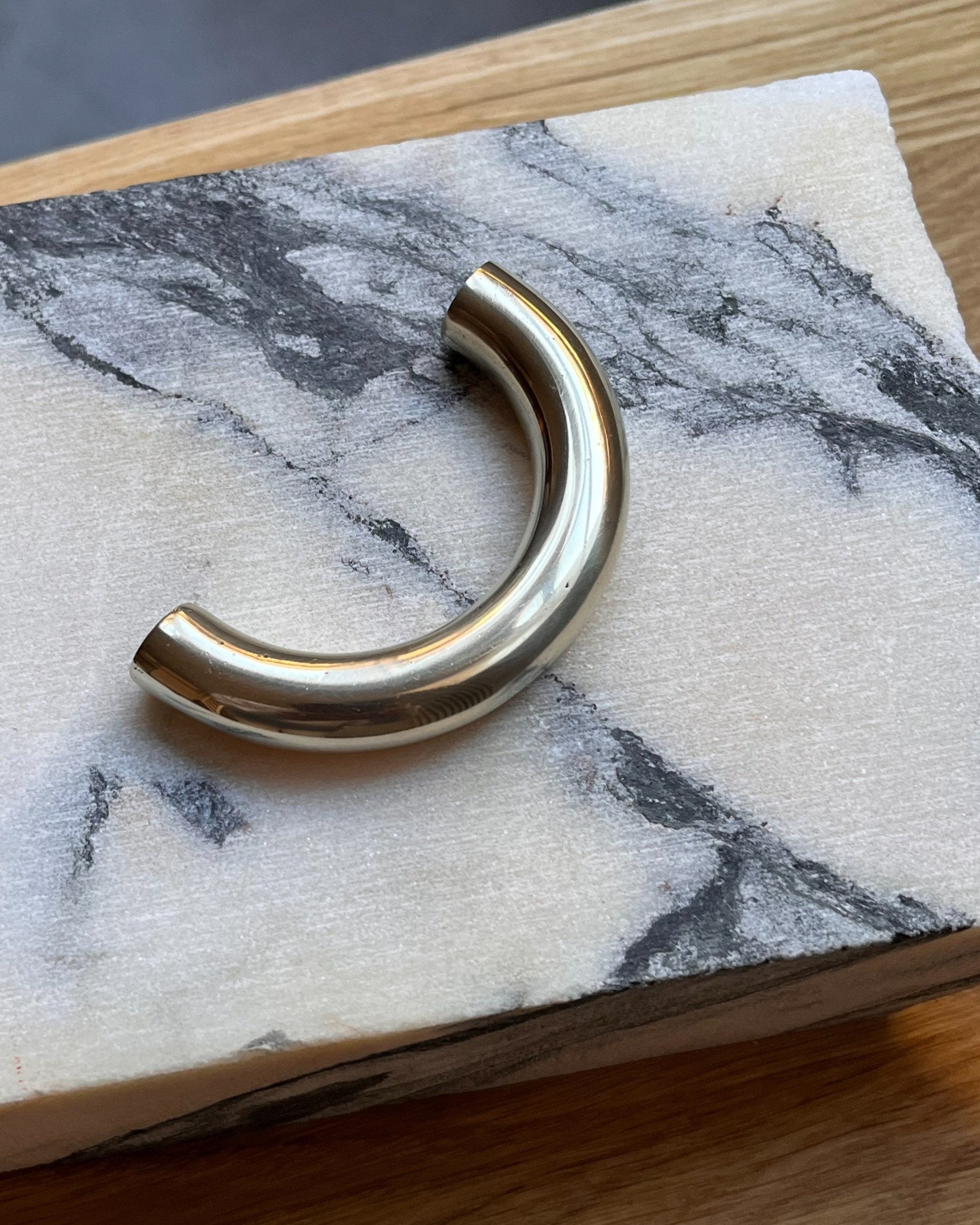 CERCLE Cabinet Pull Thin (2 sizes) — close-up of polished brass on marble