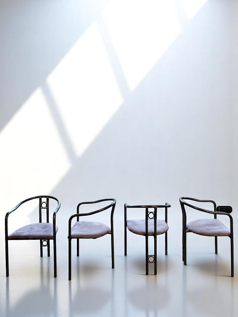 Four postmodern dining chairs with black metal frames and purple seats