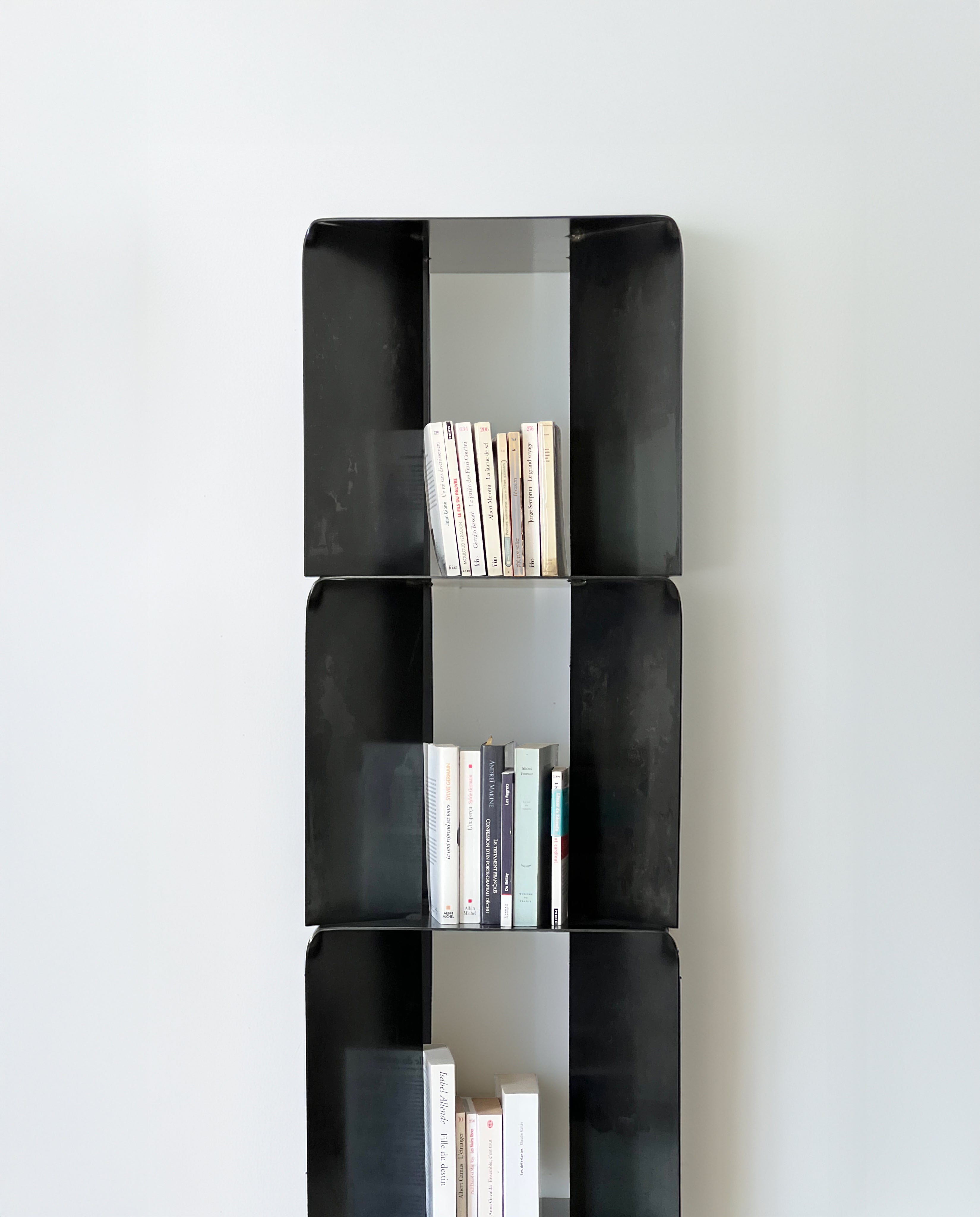 TOMO Shelves — black metal shelves with books in modern setting