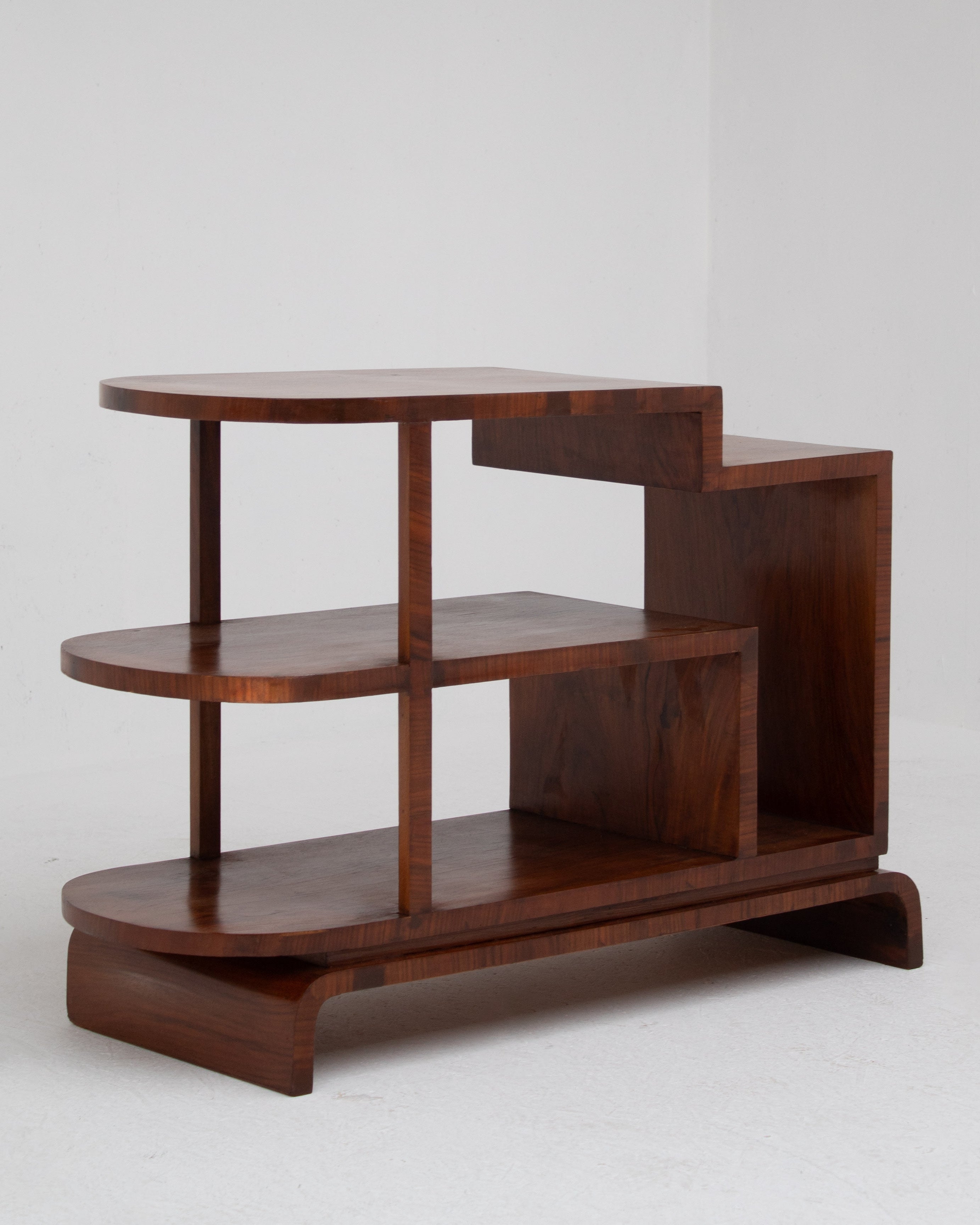 Wooden shelf with three tiers on a white background