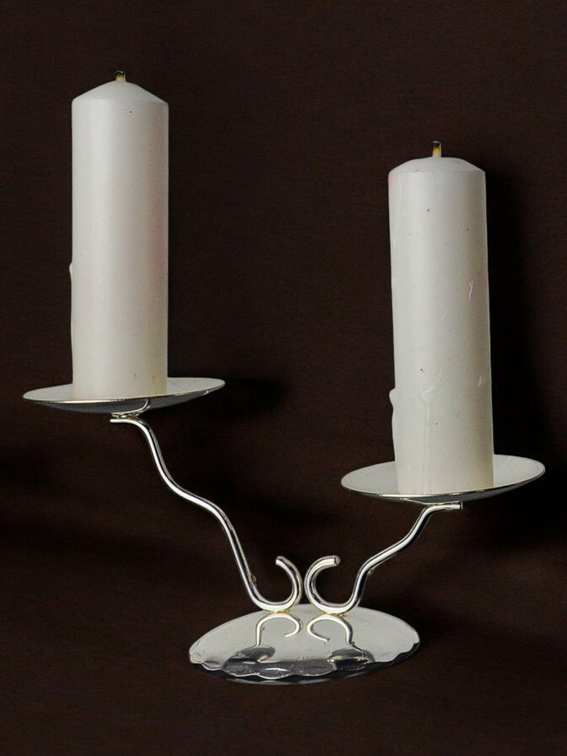 Art deco Candleholder, Spain, 1980s — close-up of silver metal base with two white candles