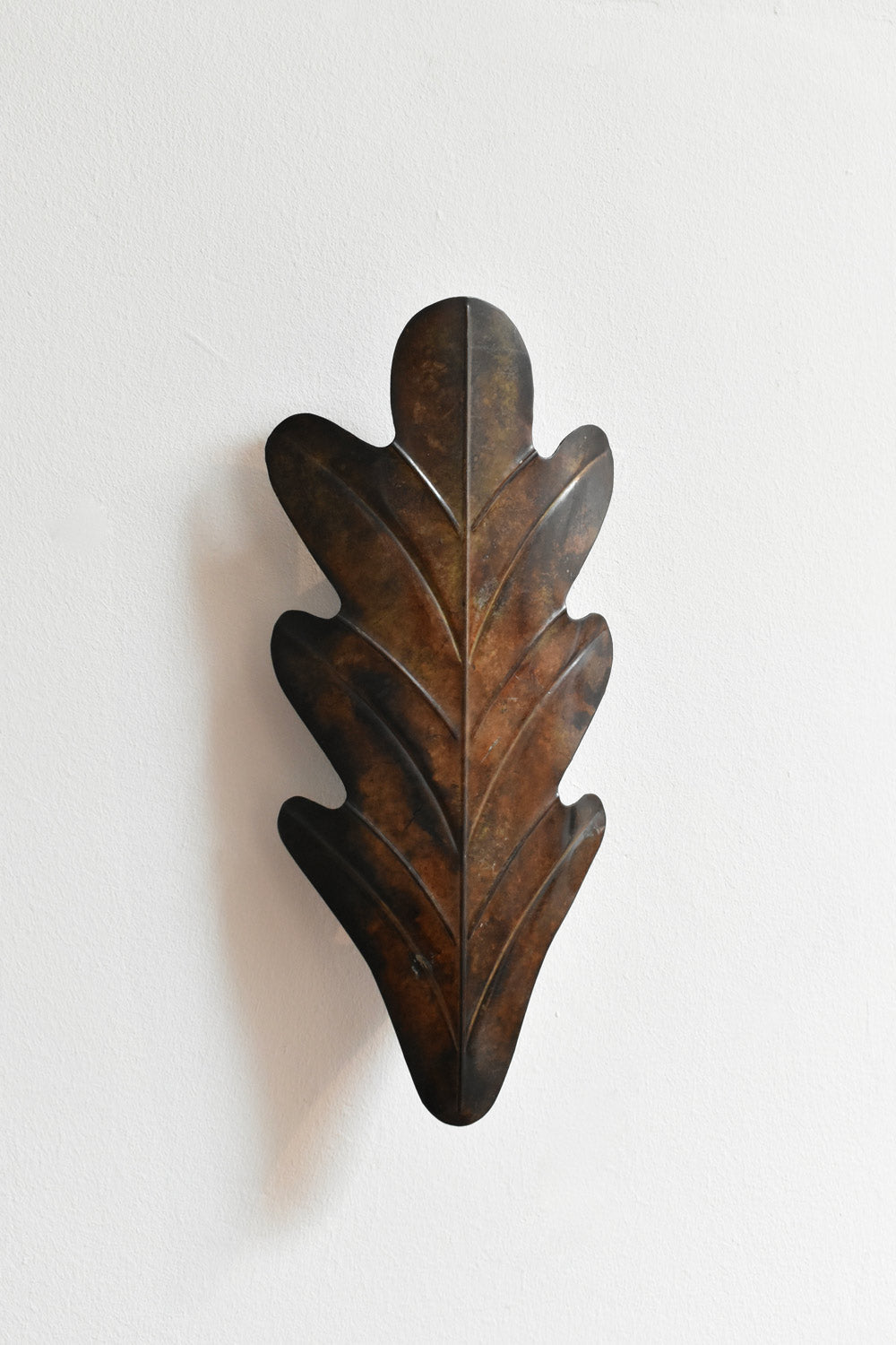 Pair of Painted Metal Acanthus Leaf Wall Sconces, 1970s — front view against white wall