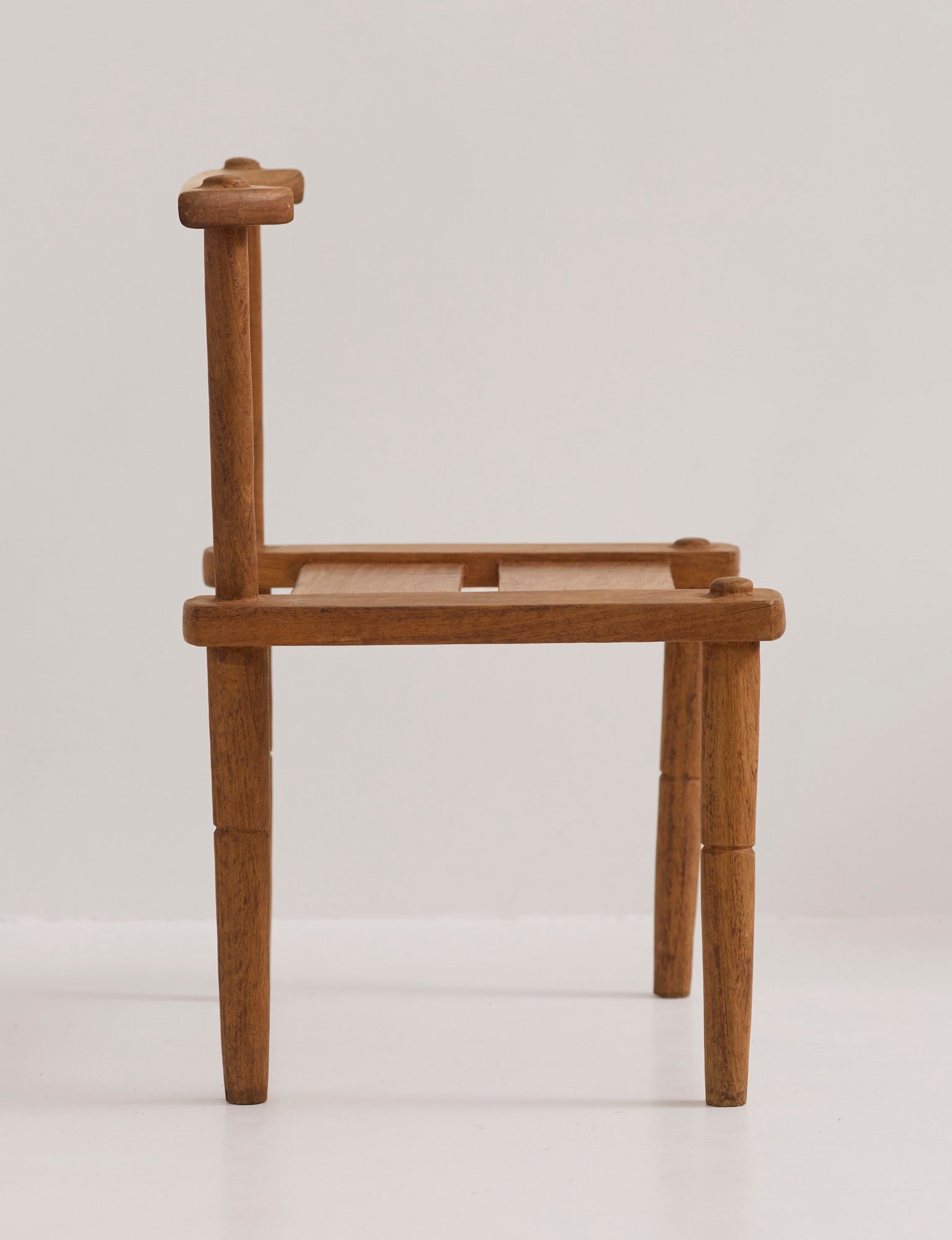 Large one-of-a-kind Baoulé chair in solid wood — side angle