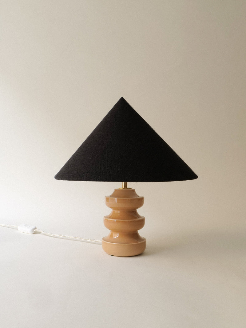 Black conical lampshade ceramic table lamp with stacked base