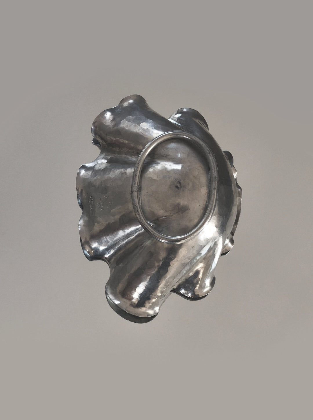 Pewter shell vide poche showing reflective metallic surface detail