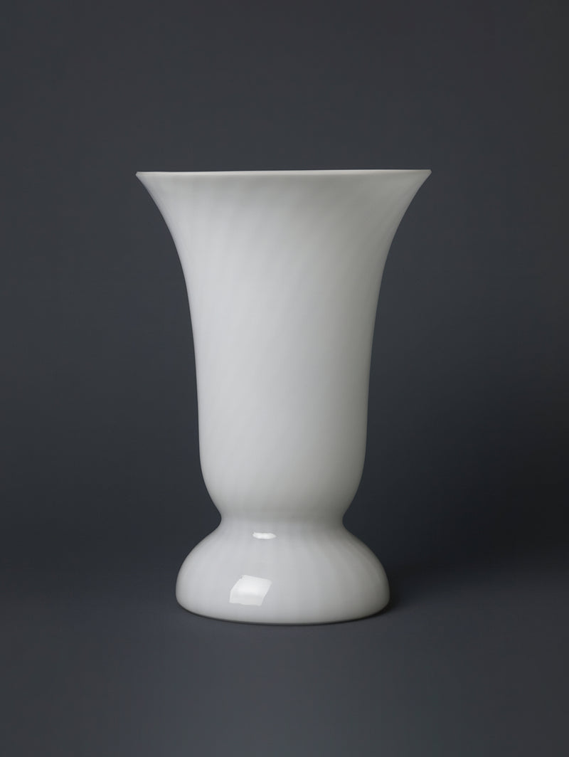 The Dodo Vintage Mid Century Murano Swirl Glass Table Lamp features a glossy white goblet-shaped base with a flared mouth and swirl pattern, inspired by classic designs, shown against a dark gray background.