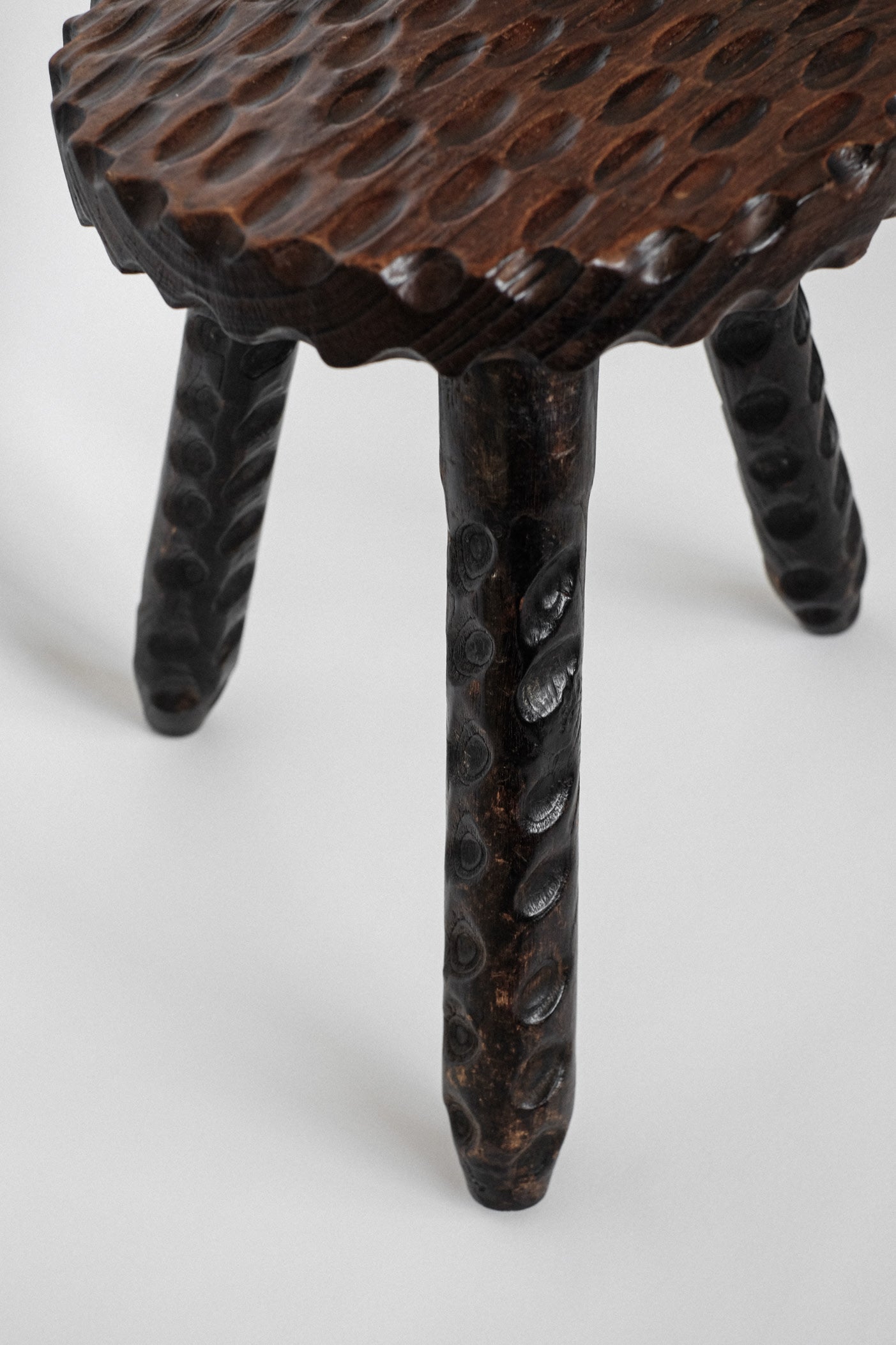 Hand-carved Wooden Tripod Stool — lifestyle setting