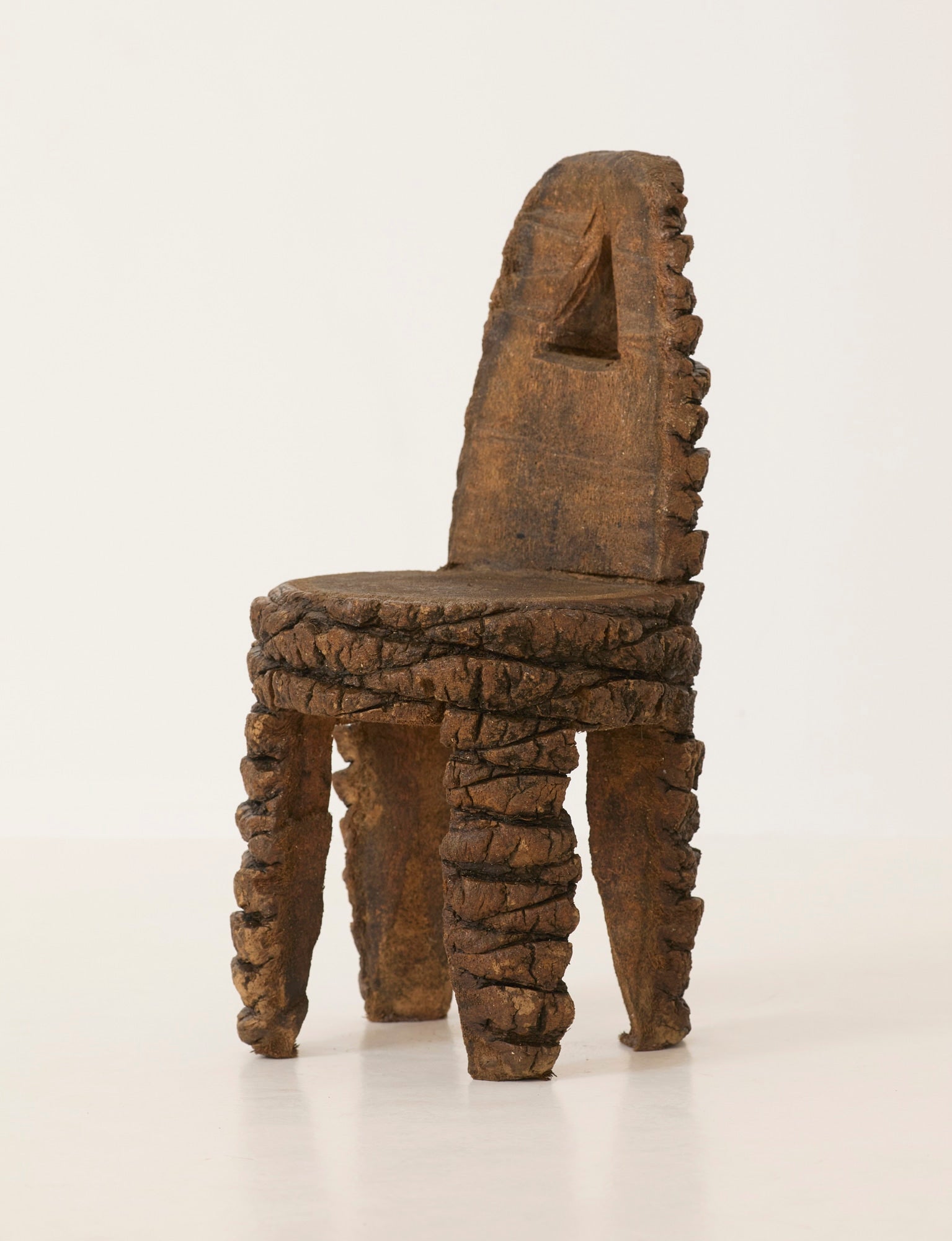 Small Artisanal Brutalist Chair in Solid Palm Tree C. 1970 — side angle highlighting textured wood finish