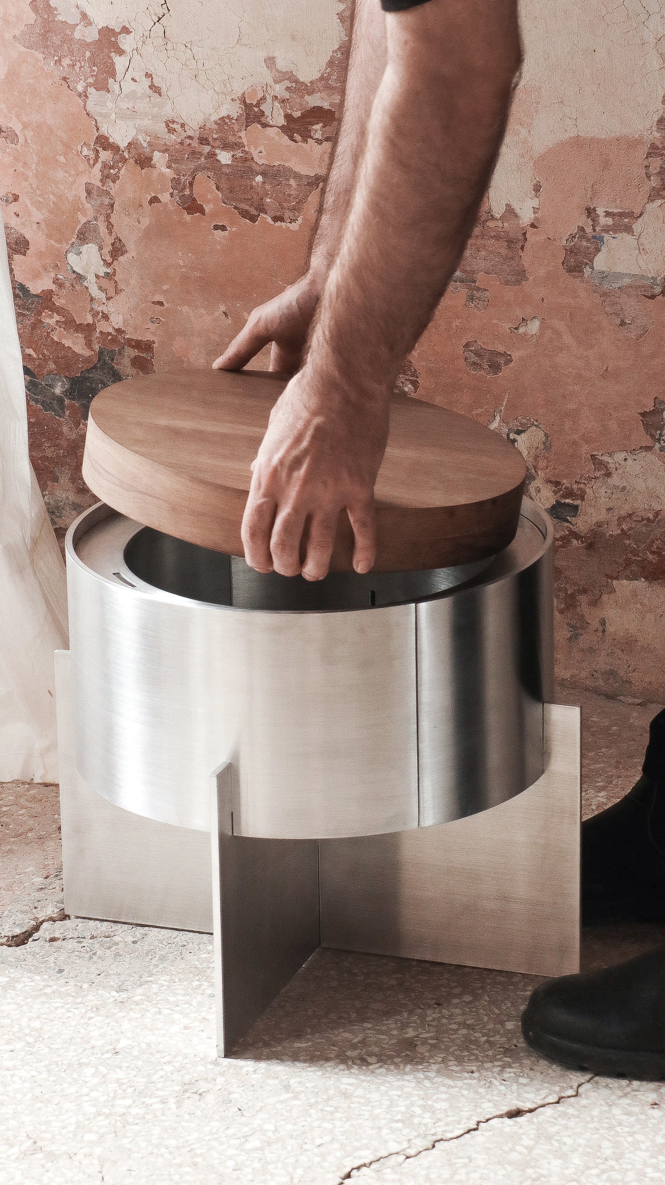 Lunar Side Table — person placing wooden top on metal base