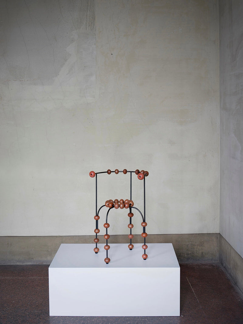 The "Buoys" Chair — close-up of wooden beads on metal frame