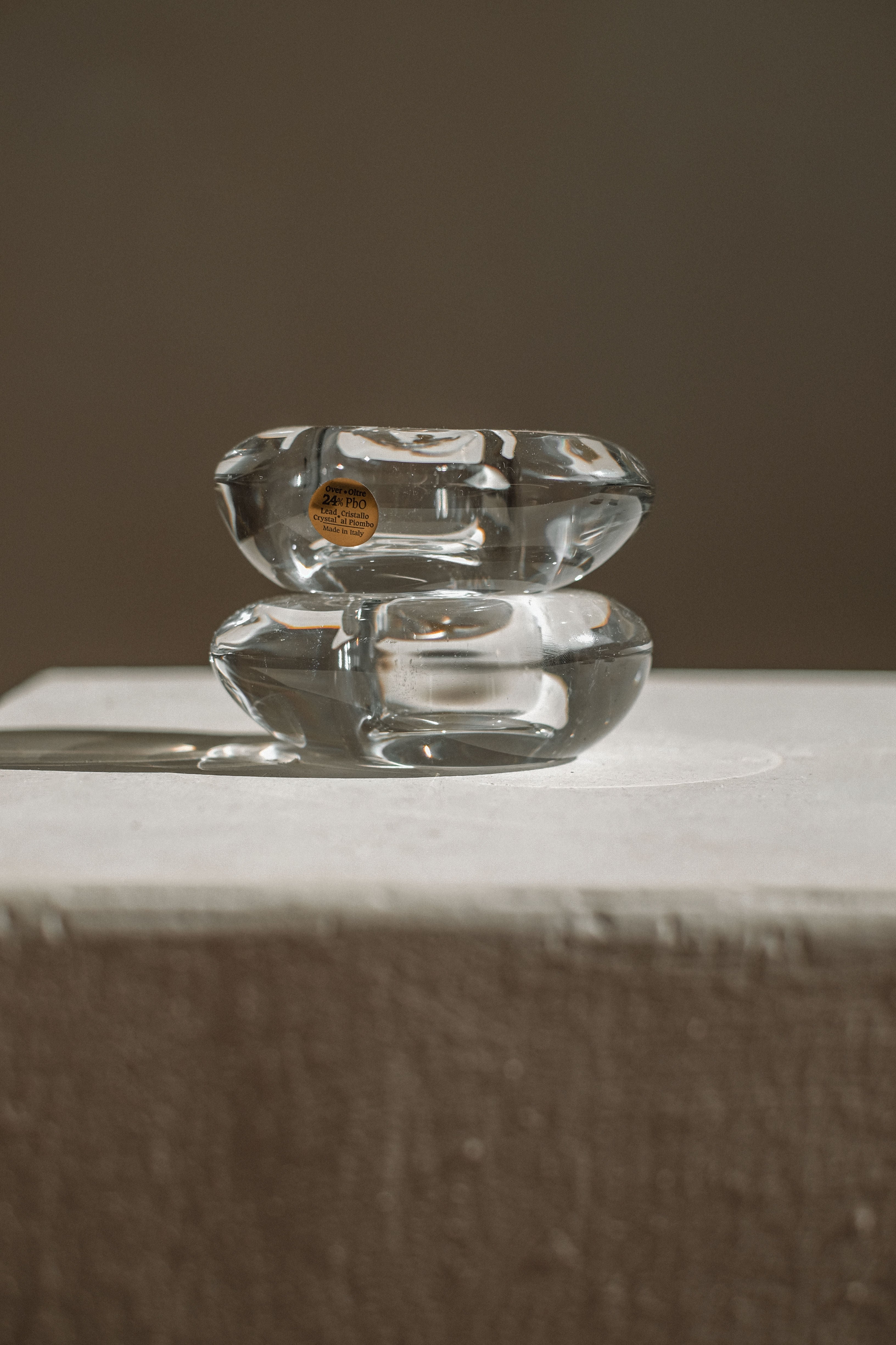 Two stacked crystal candleholders with smooth curved design