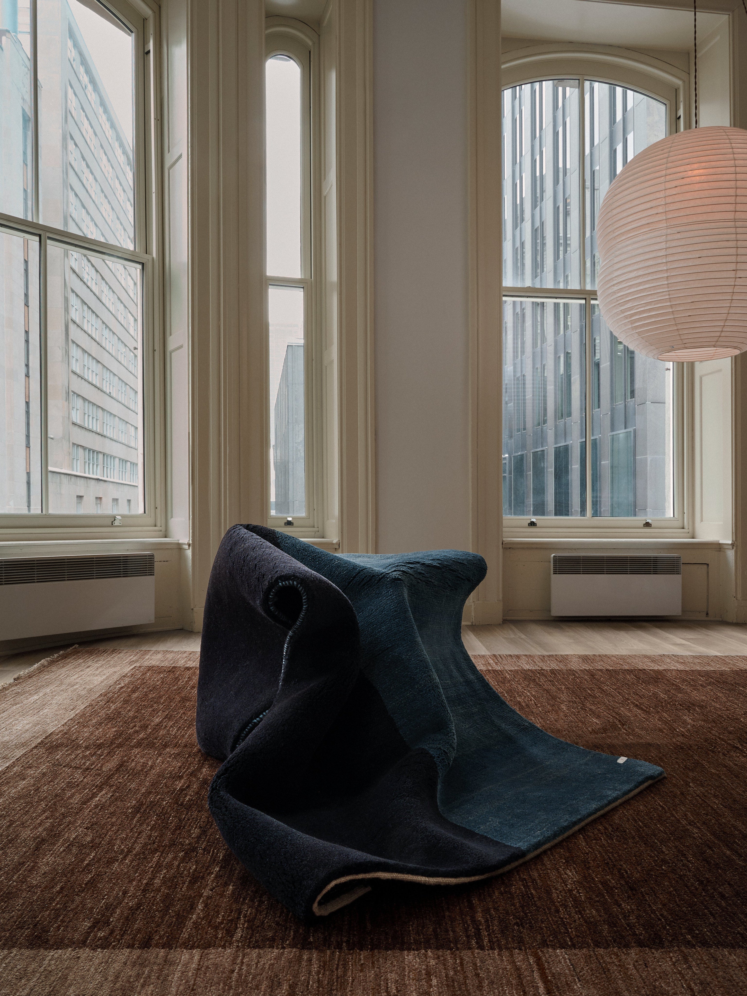 Gabbeh Rug in Cobalt 119 x 177 cm — close-up of folded rug in modern interior