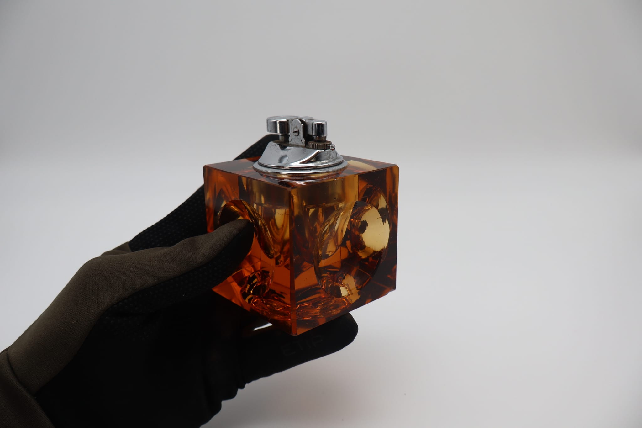 Lighter by Antonio Imperatore, orange murano glass, Italy, 1970 — held in hand showing square design