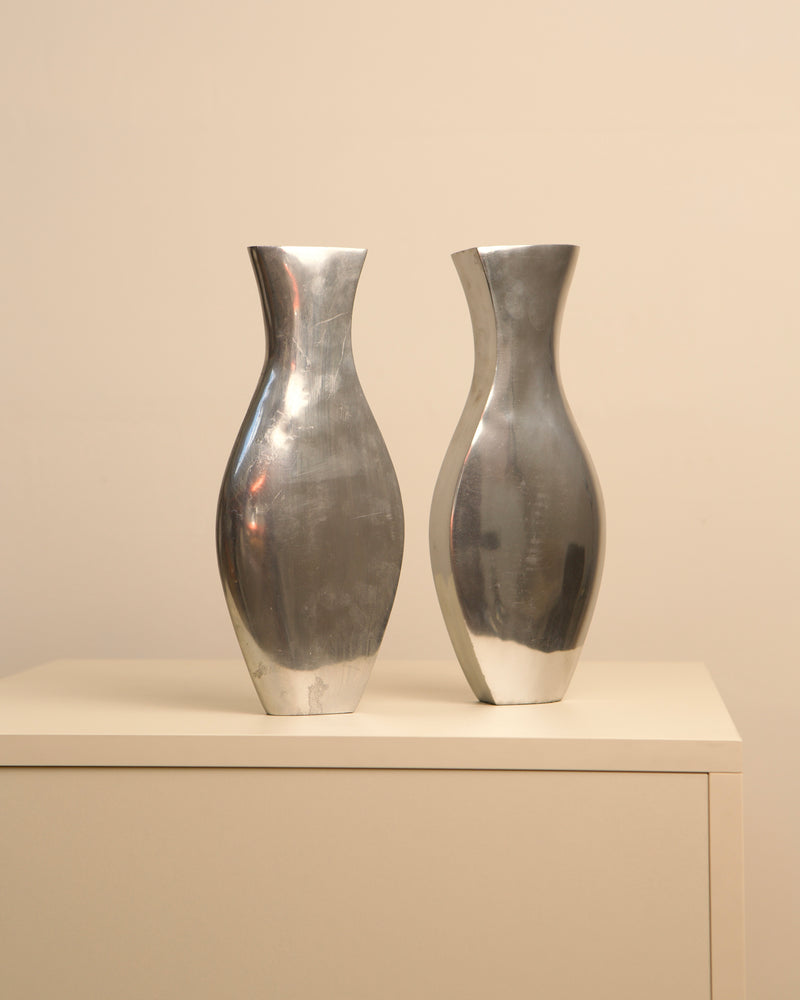 Pair of Italian cast aluminum Dame vases on minimalist shelf