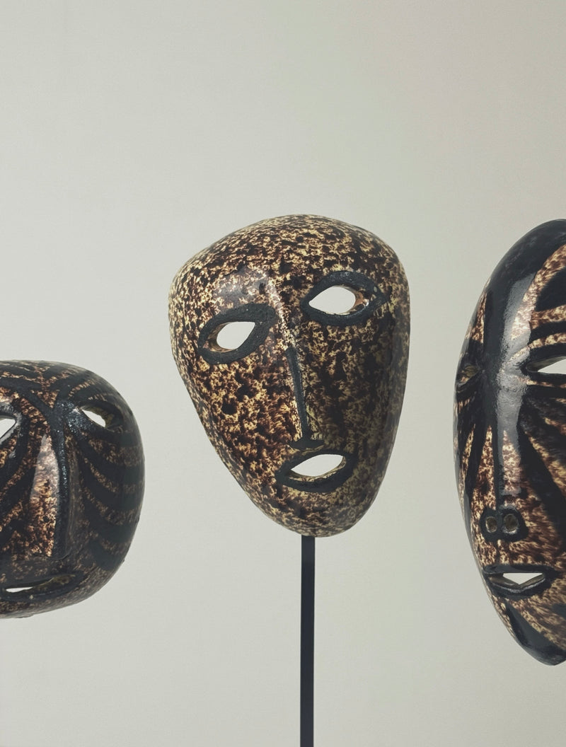Set of three ceramic masks with textured golden-brown glaze by Accolay