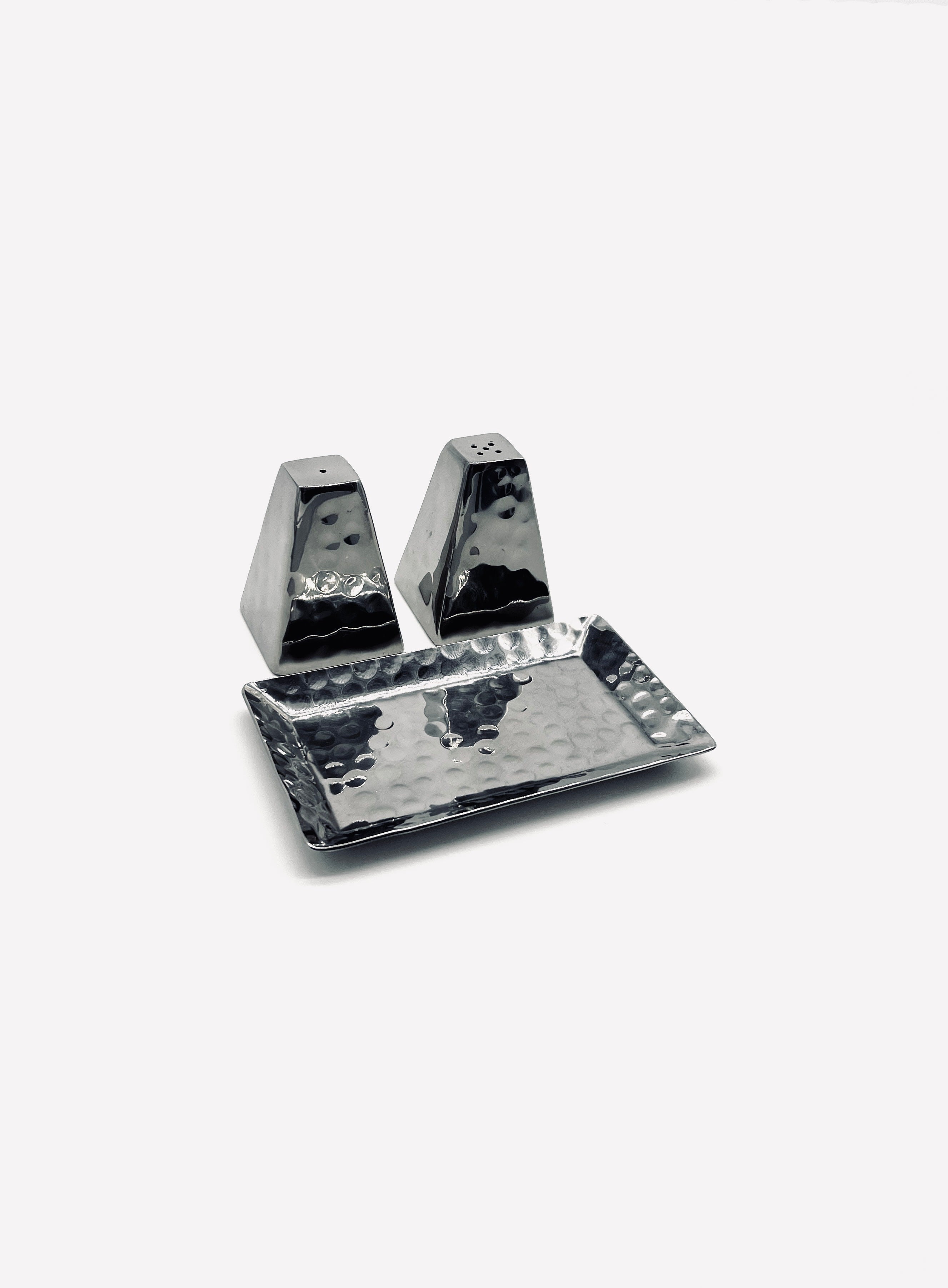 Hammered stainless steel salt and pepper shakers on matching tray