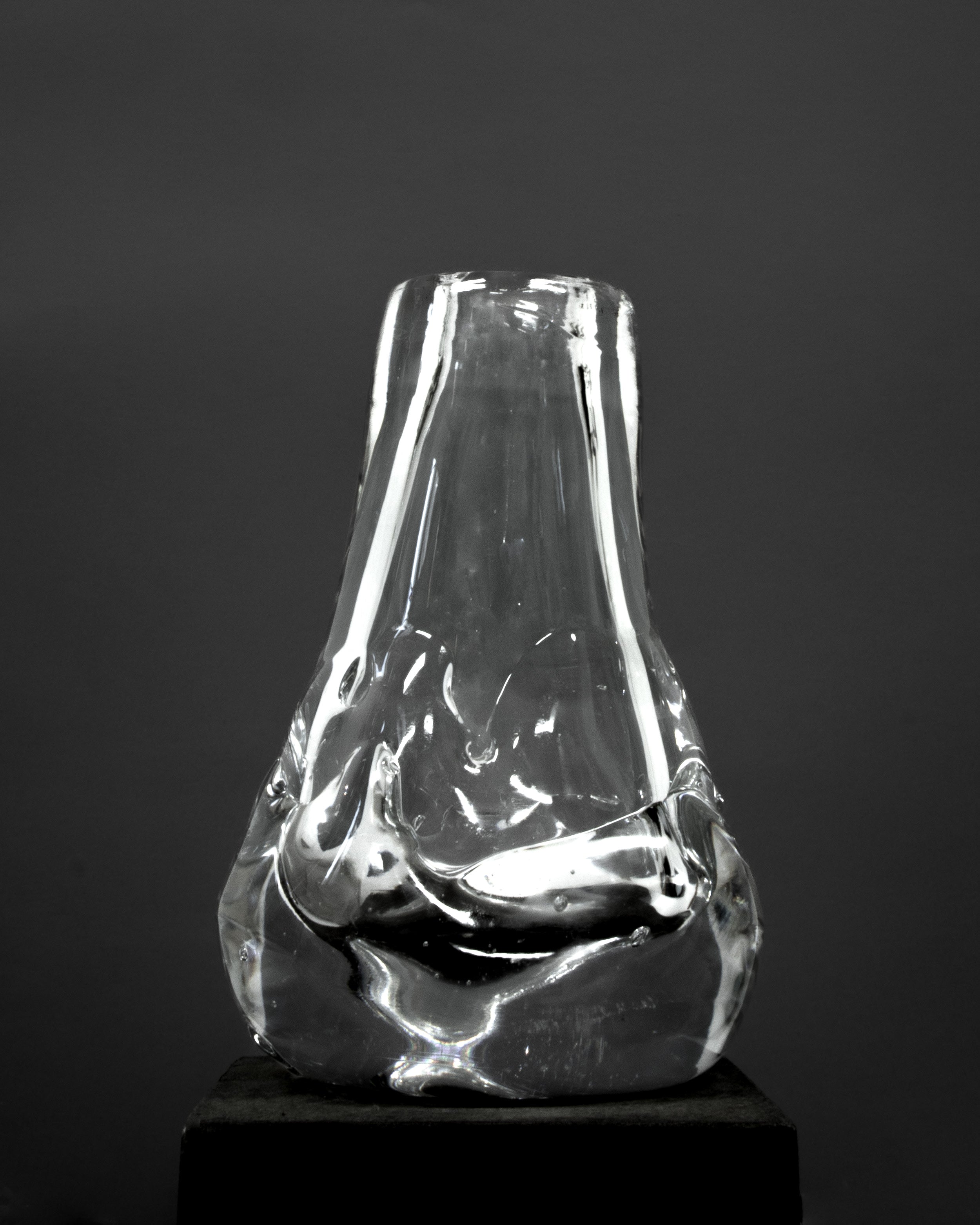 Drop Shaped Hand-blown Vase — clear glass vase on dark pedestal