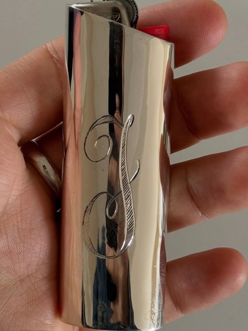 Monogram Lighter Case Small Size — close-up of polished metal surface with engraving