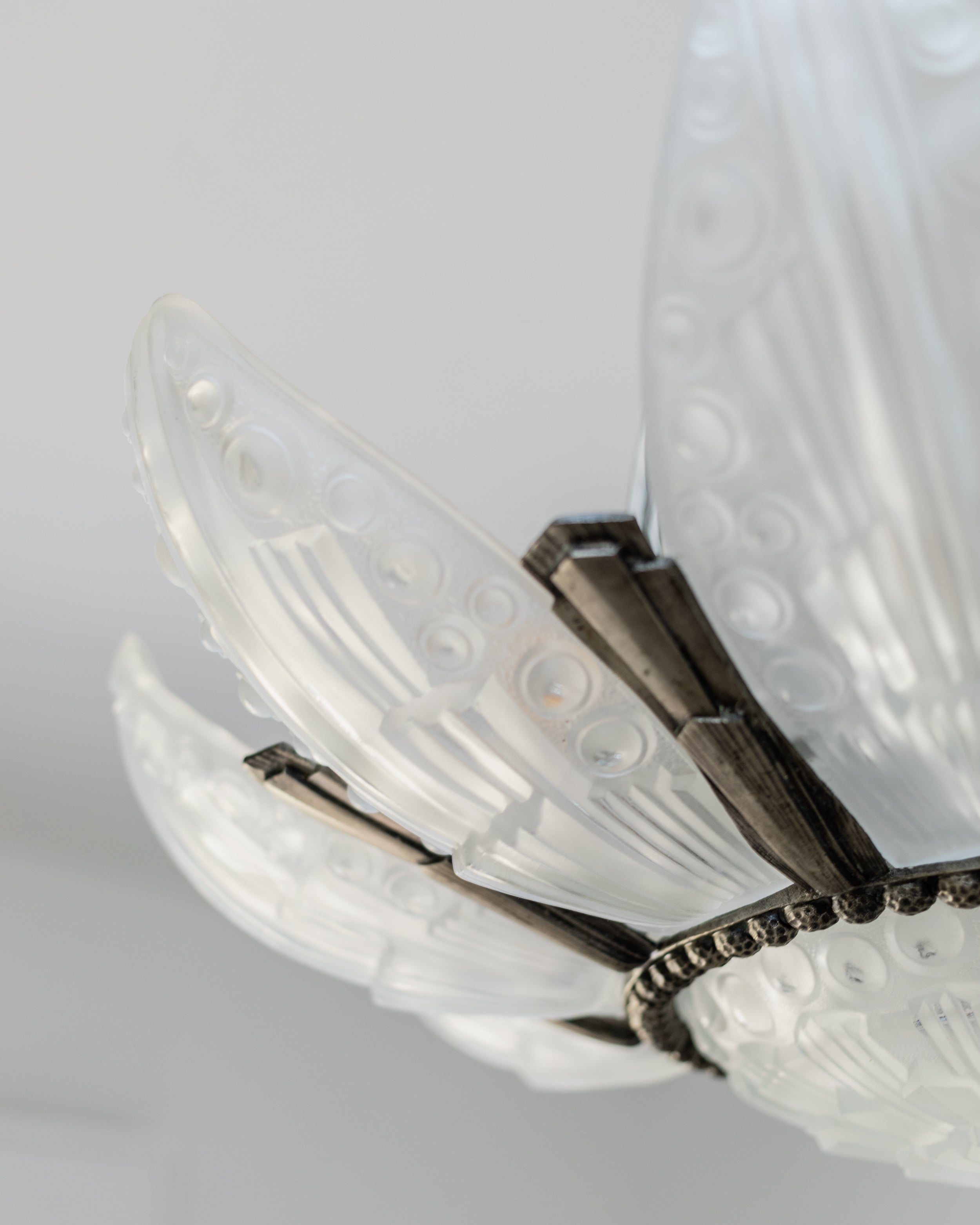 Close-up detail of Art Deco crystal chandelier ornate metalwork