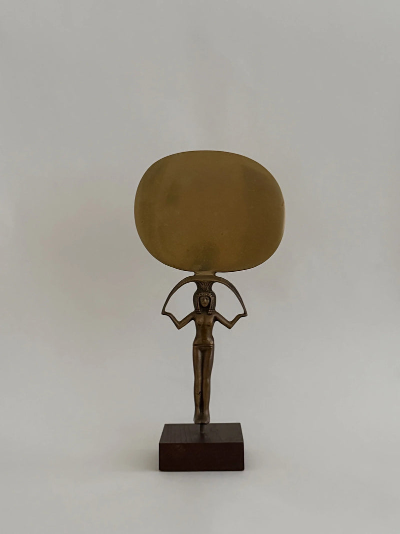 Bronze Sculpture of Isis Holding a Mirror — close-up of bronze figure with large mirror