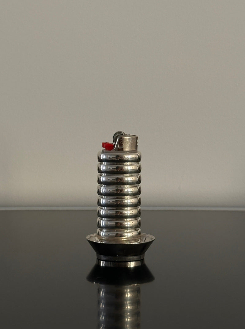 Gio Lighter Holder — close-up of shiny metal surface on black table