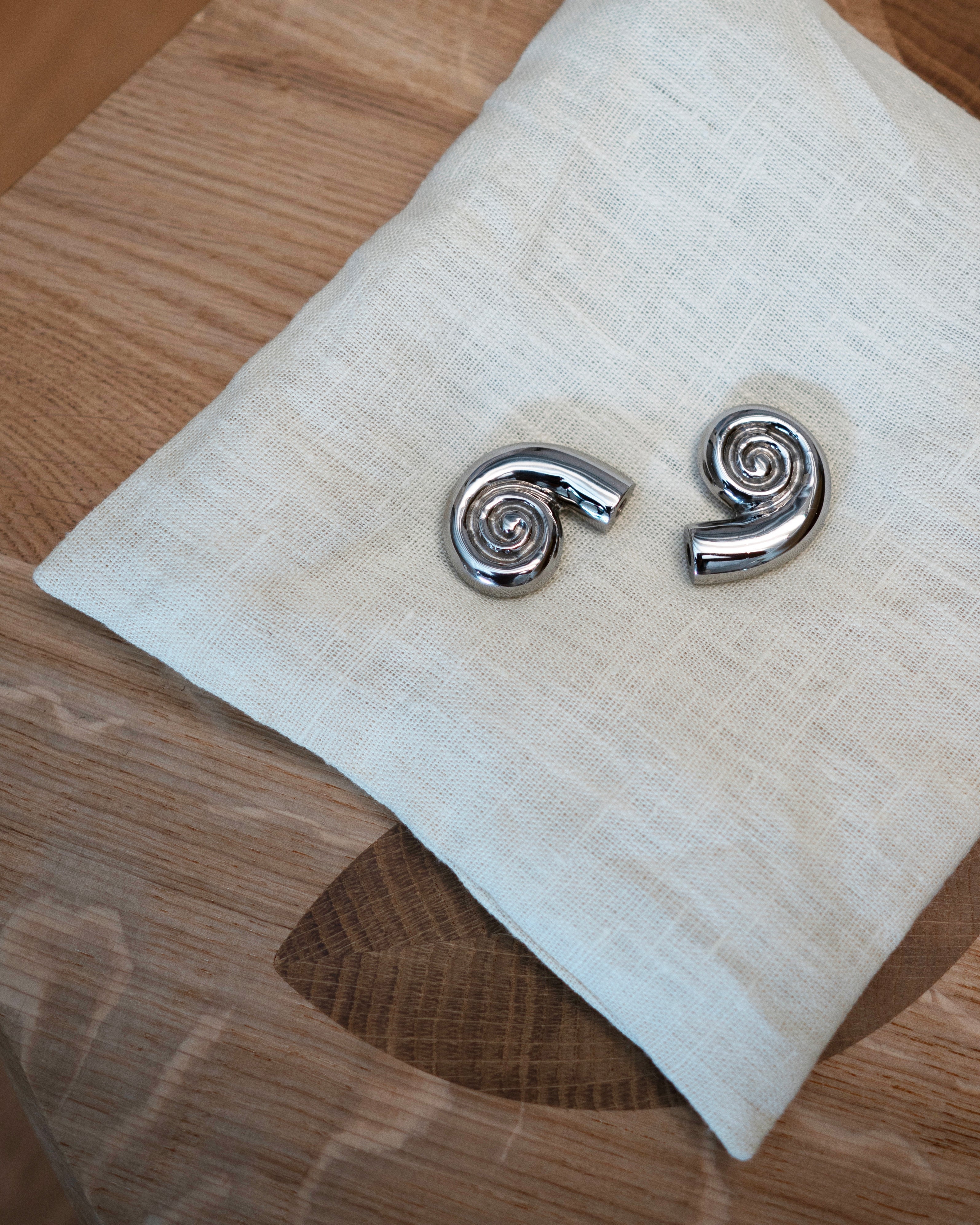 Noelle Knob - Titanium — top view on linen cloth with wood surface