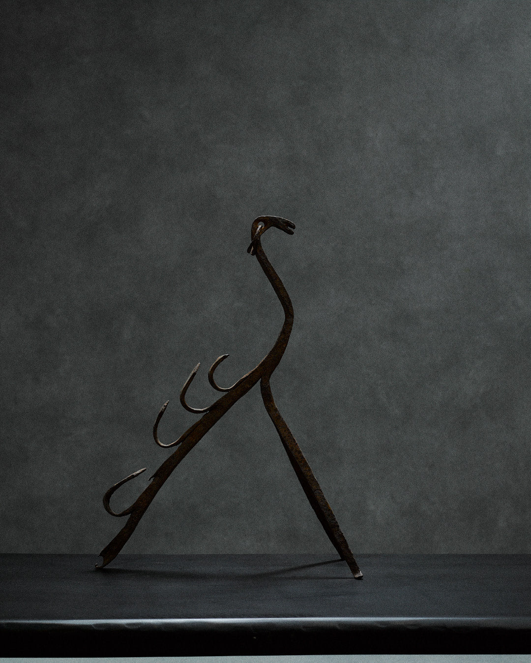 handcrafted iron sculpture with primal animal motifs — top view highlighting curved iron details