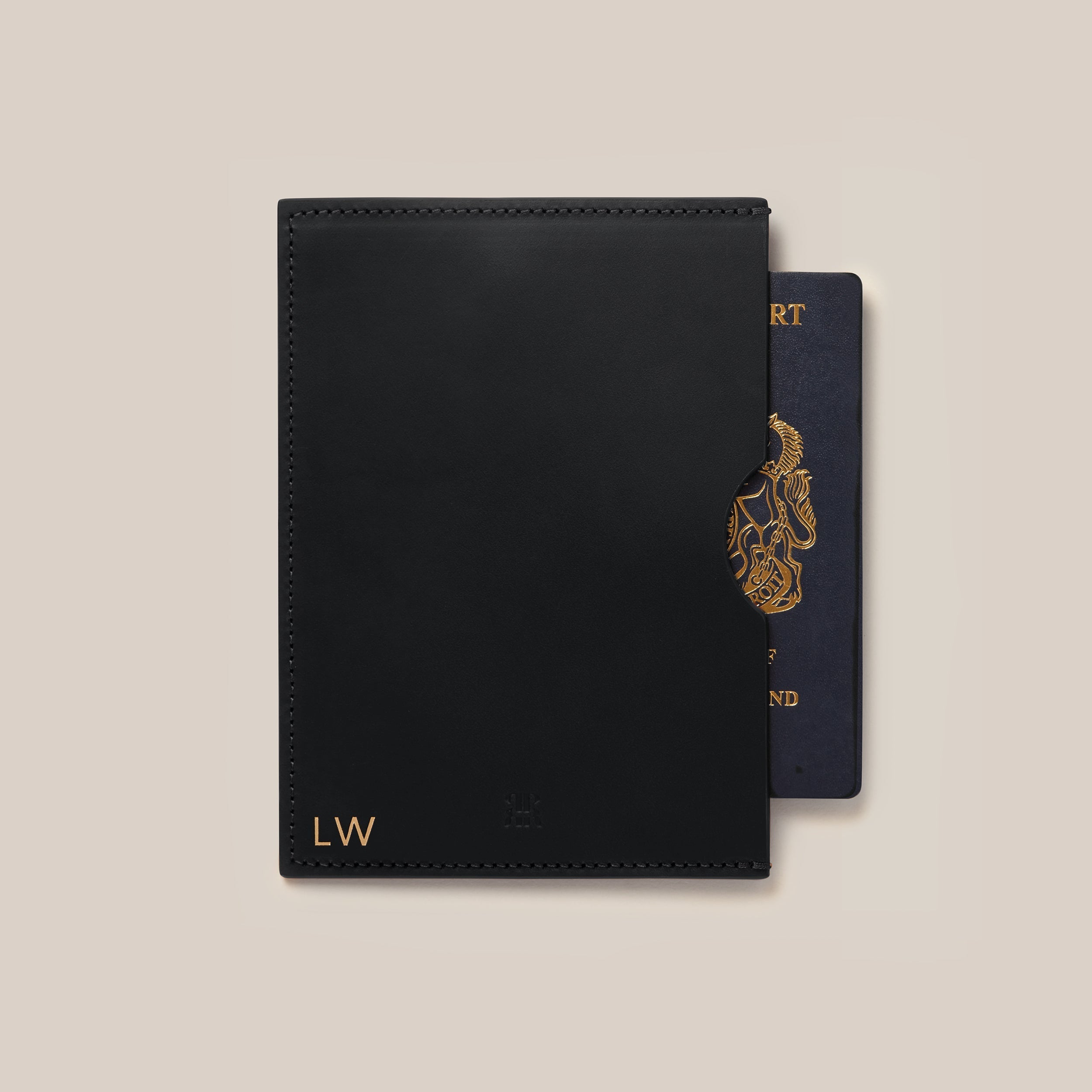 Leather Passport Holder — front view with black leather and passport peeking out