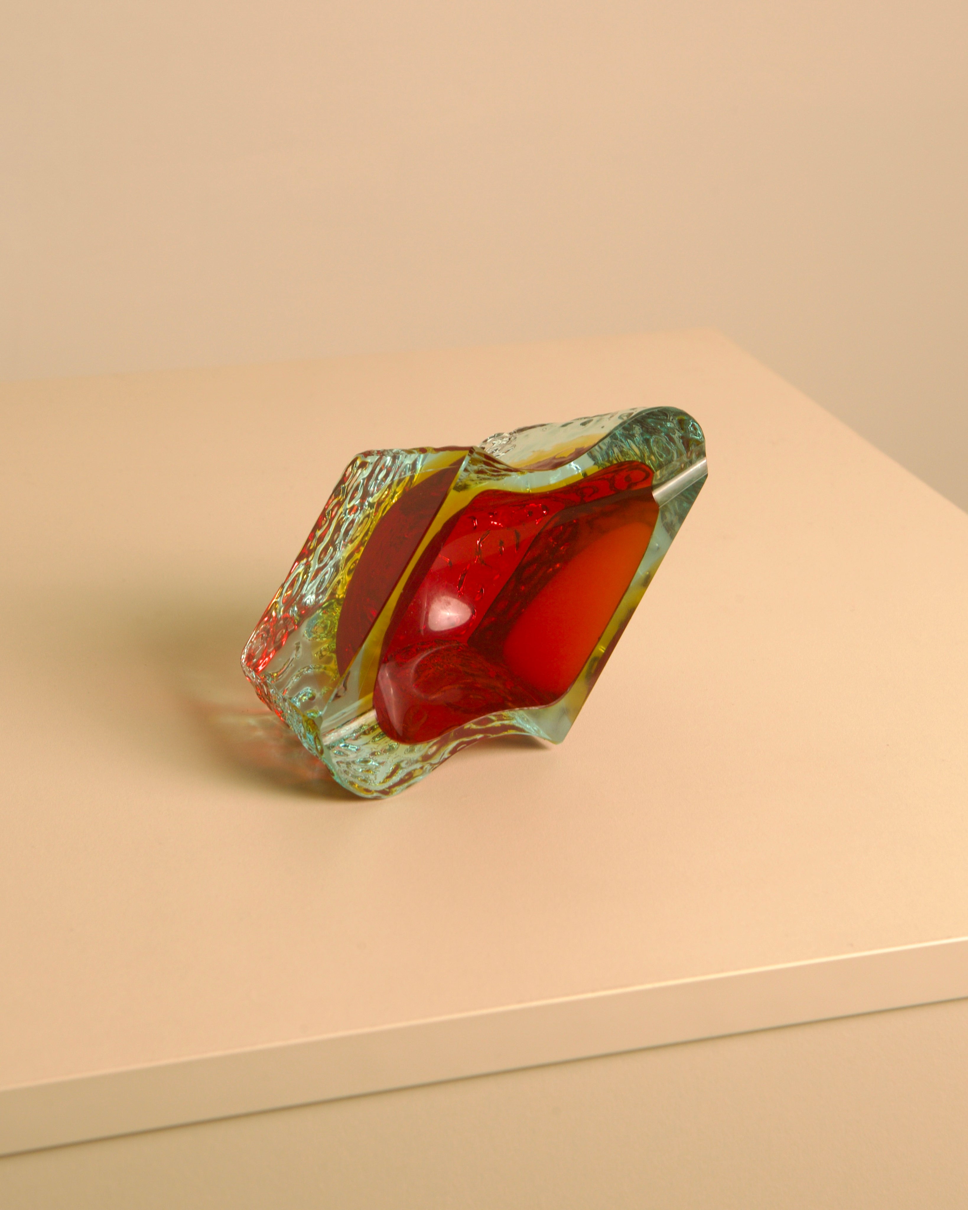 Wave ashtray in Red Murano Glass by Flavio Poli for Seguso, 1960s — angled view on light-colored surface