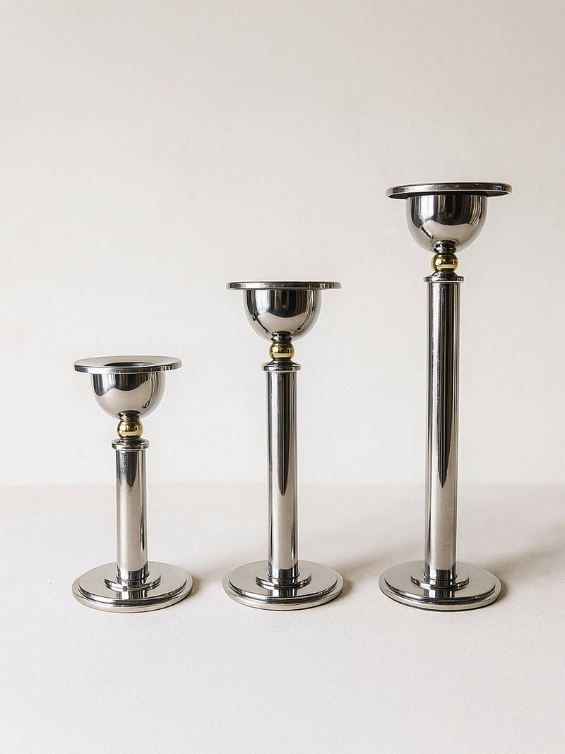 Three graduated silver postmodern candle holders from the 1980s