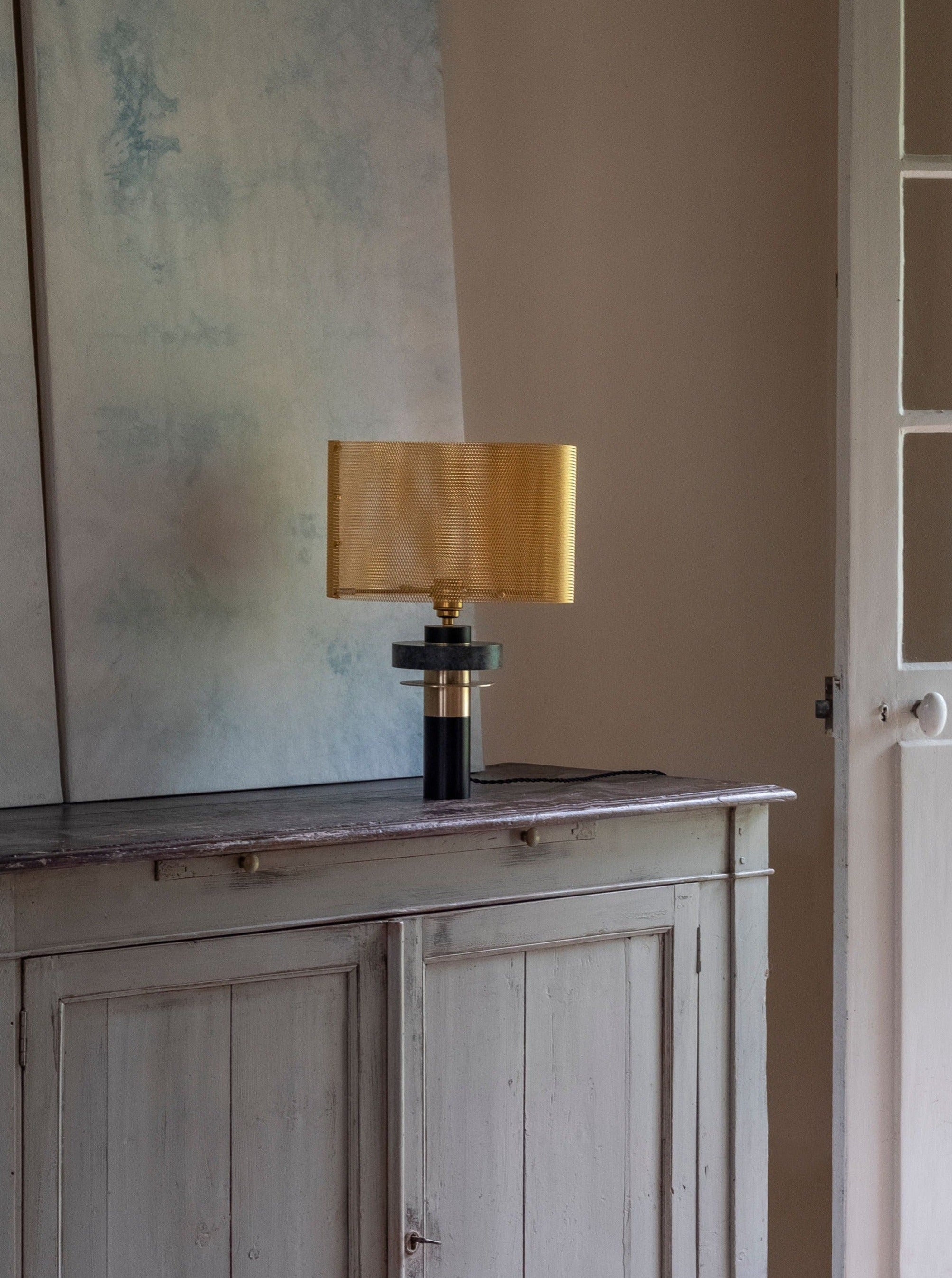 Dyane Table Lamp — back view with gold shade on wooden console
