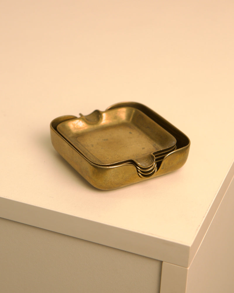 Brass ashtray detail showing curved edges and golden patina
