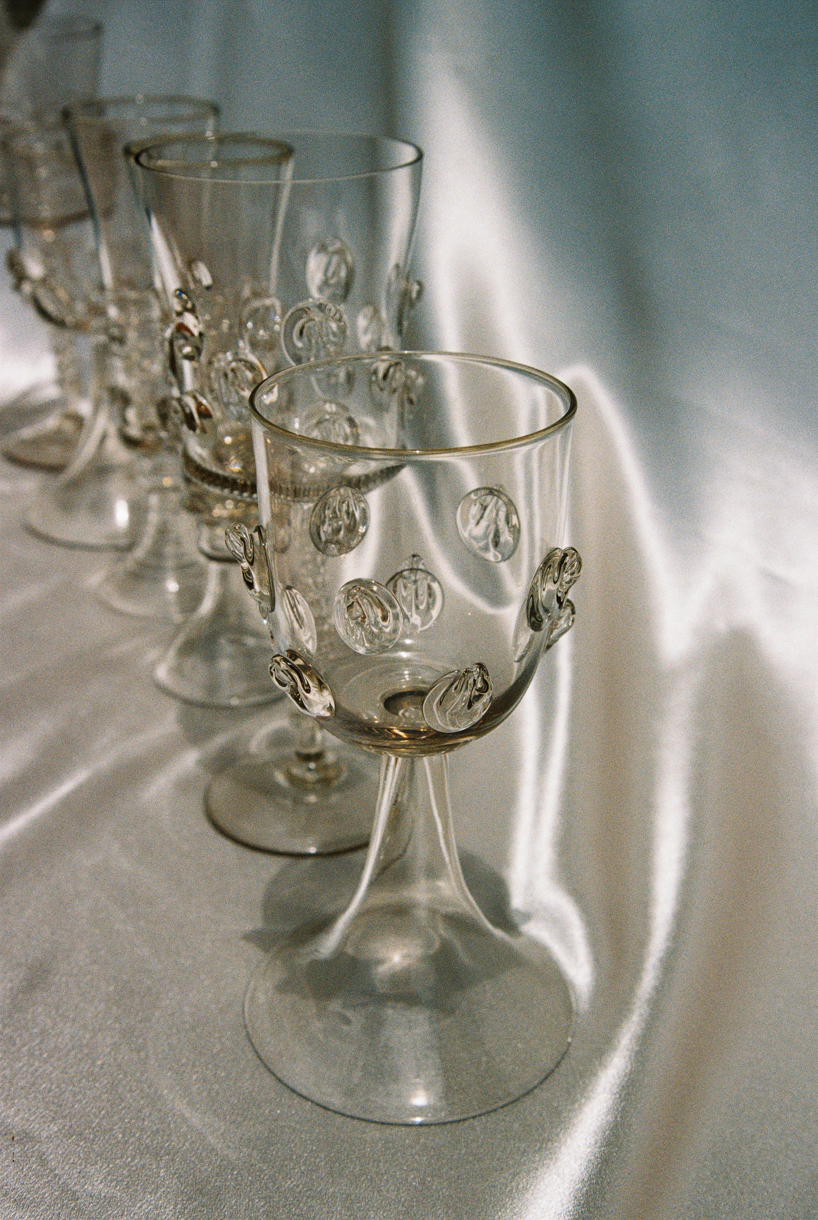 Set of six Mouthblown Wine Glasses — close-up on textured glass with decorative elements