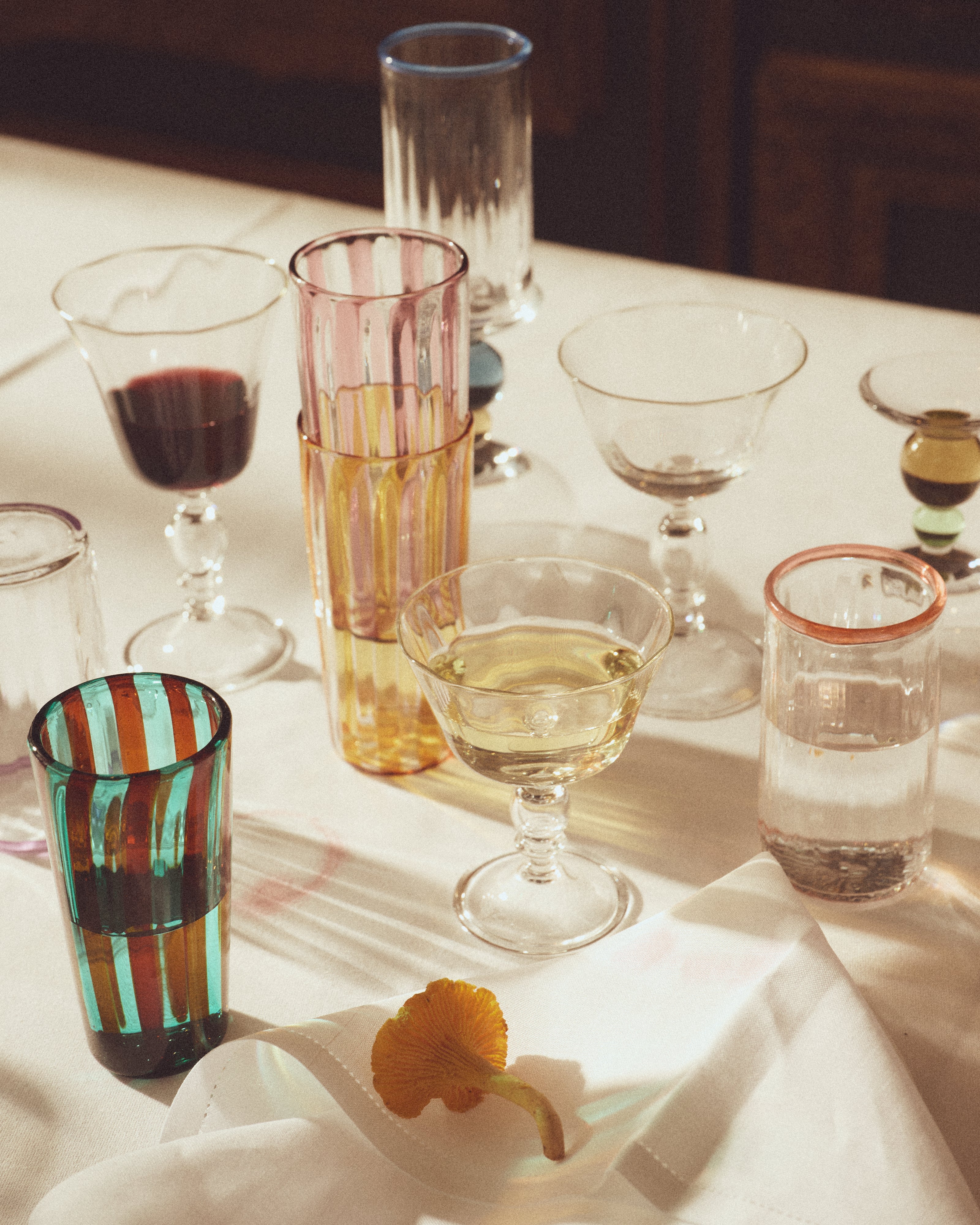 Alban Wine Glass Large - Set of Four — overhead view of colorful glassware on table