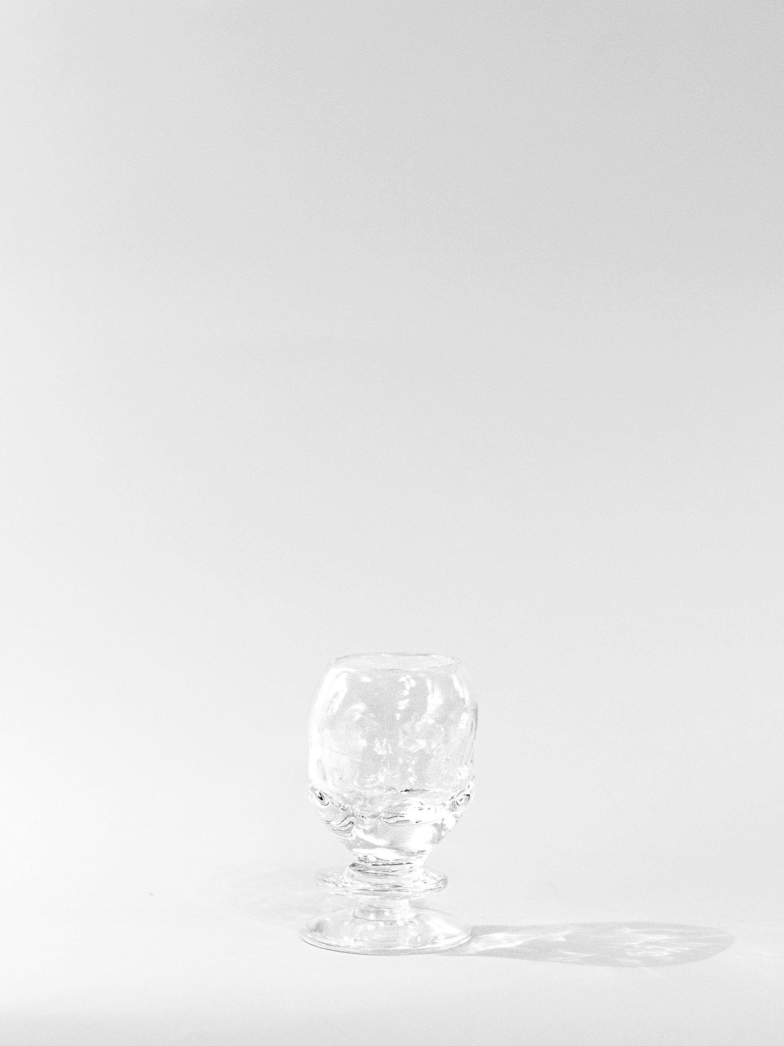 Round Free-shaped Glass — side angle on white background