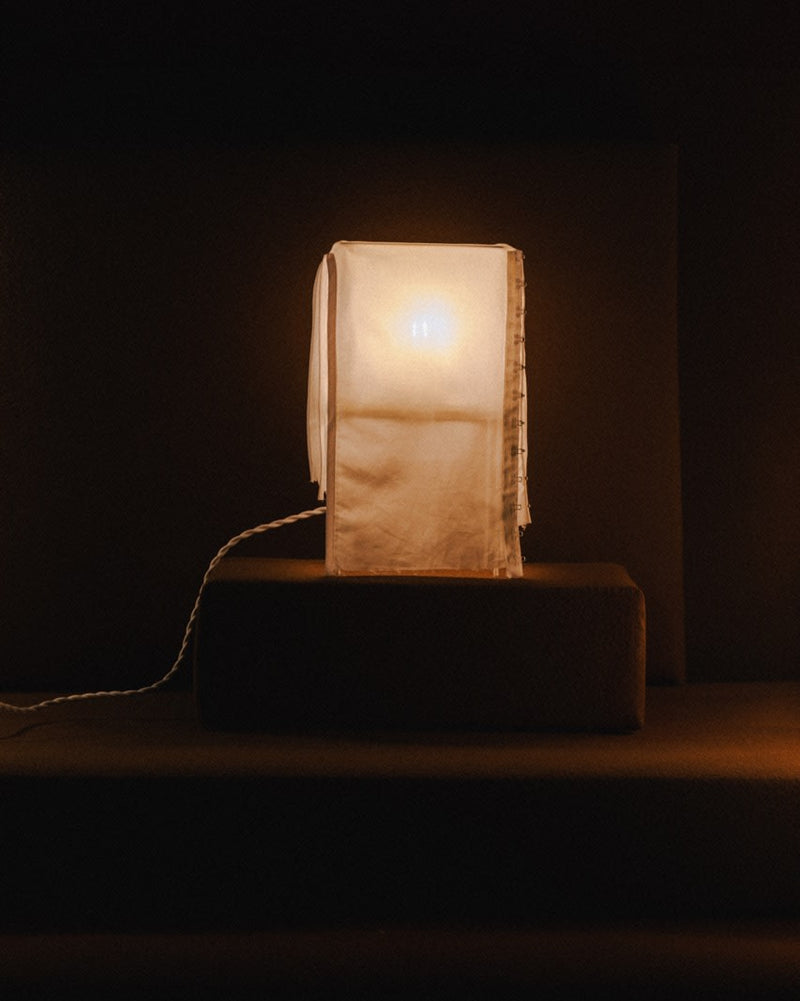 Contemporary table lamp with translucent geometric shade on dark base