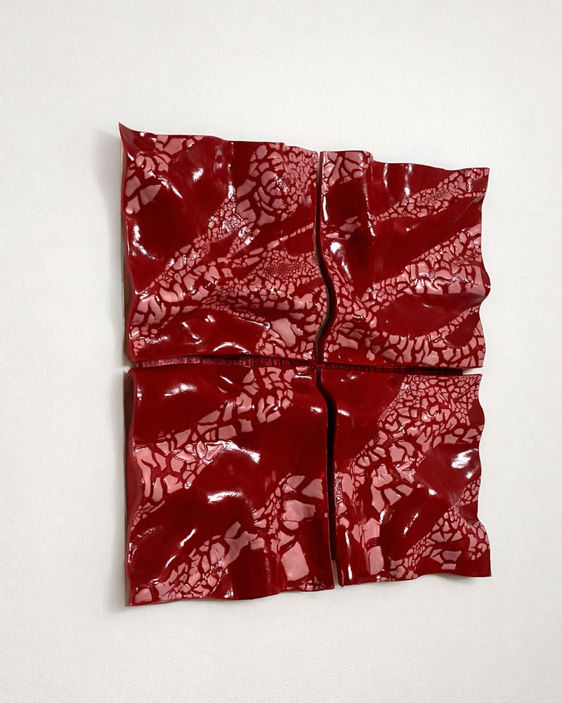 Red Ceramic Wall Sculpture — close-up of textured red surface
