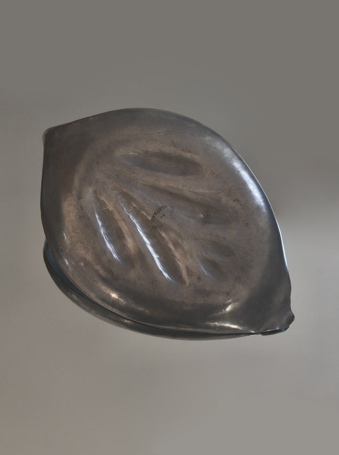 Large pewter leaf vide poche showing detailed embossed surface texture