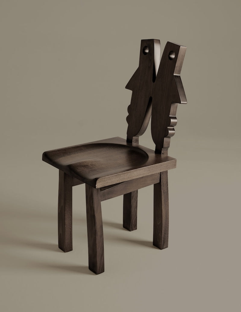 Oju Chair — angled view highlighting dark wood grain and unique backrest