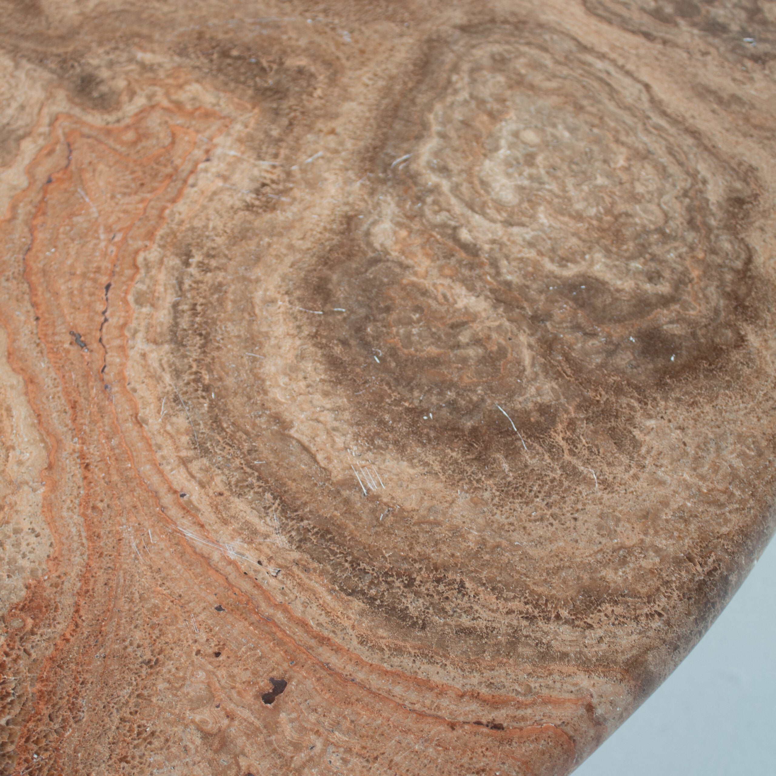 Round Marble Dining Table with Burgundy Lacquered Base — close-up of textured marble surface