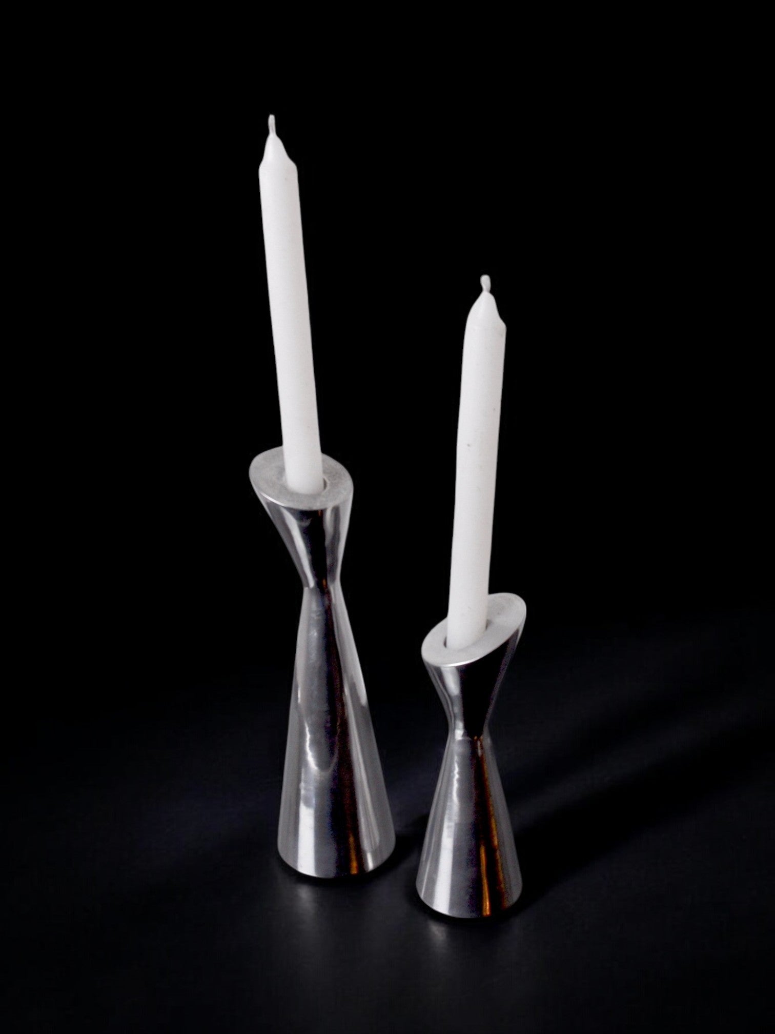 Pair of Swan candlesticks by Matthew Hilton, England, 1980 — side angle