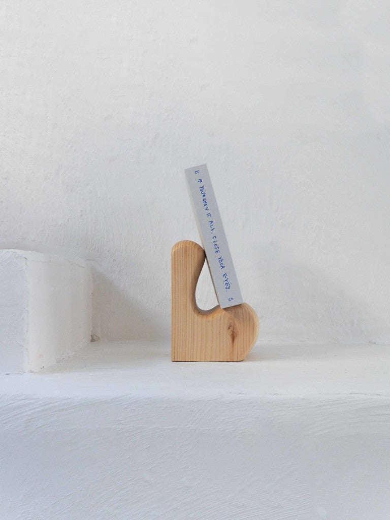 Affinités Bookends — angled view on white shelf with wood grain