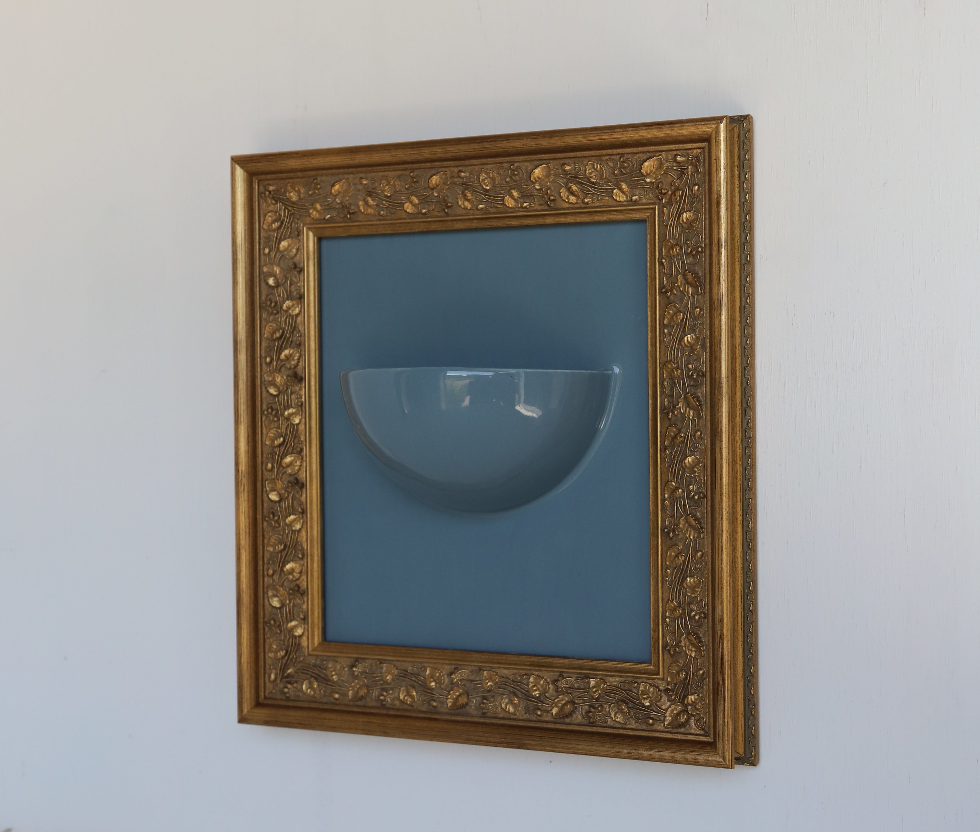 Clea Sconce — close-up of glass bowl against blue background