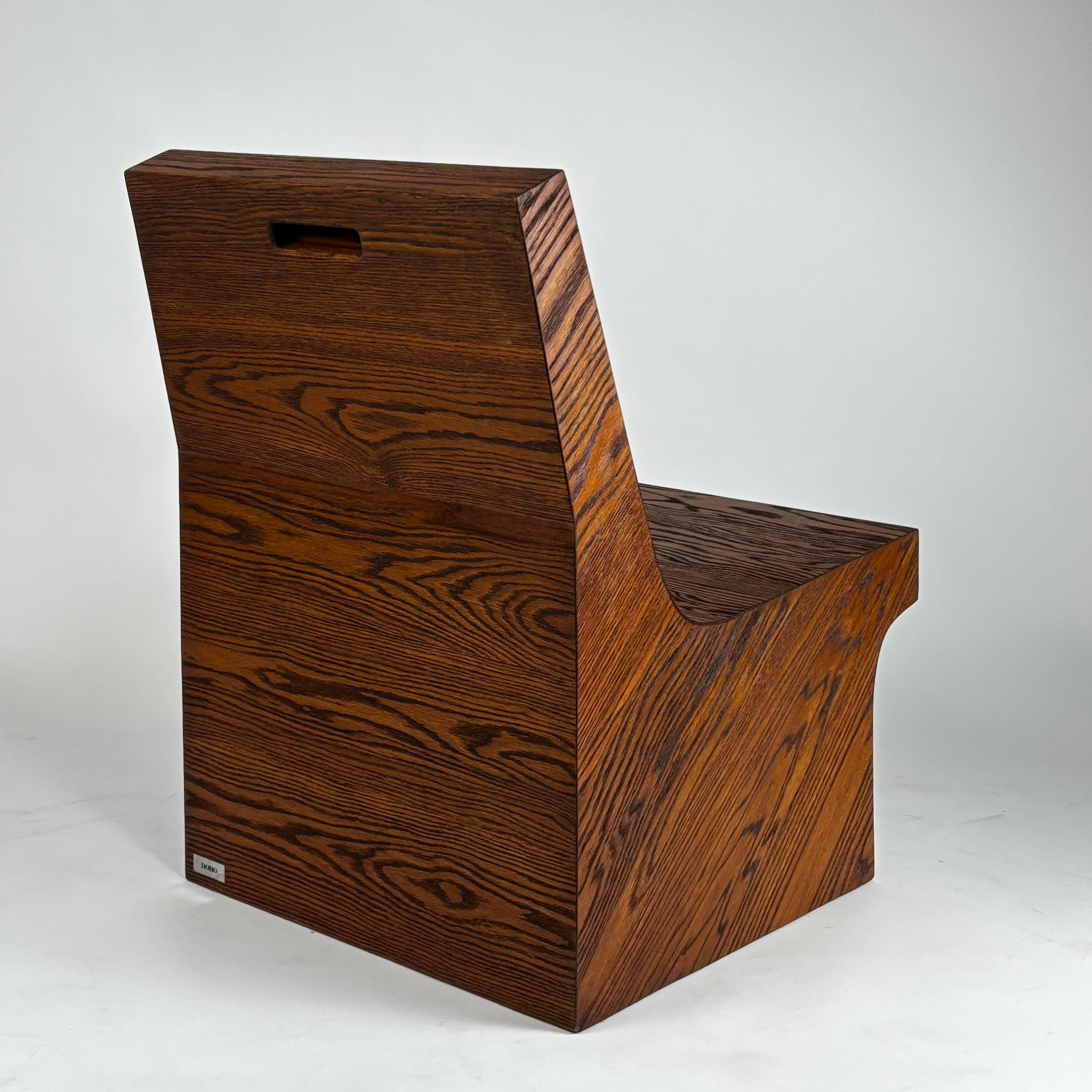Pair of NONO Lounge Chairs by Joel Escalona — angled view highlighting rich wood grain