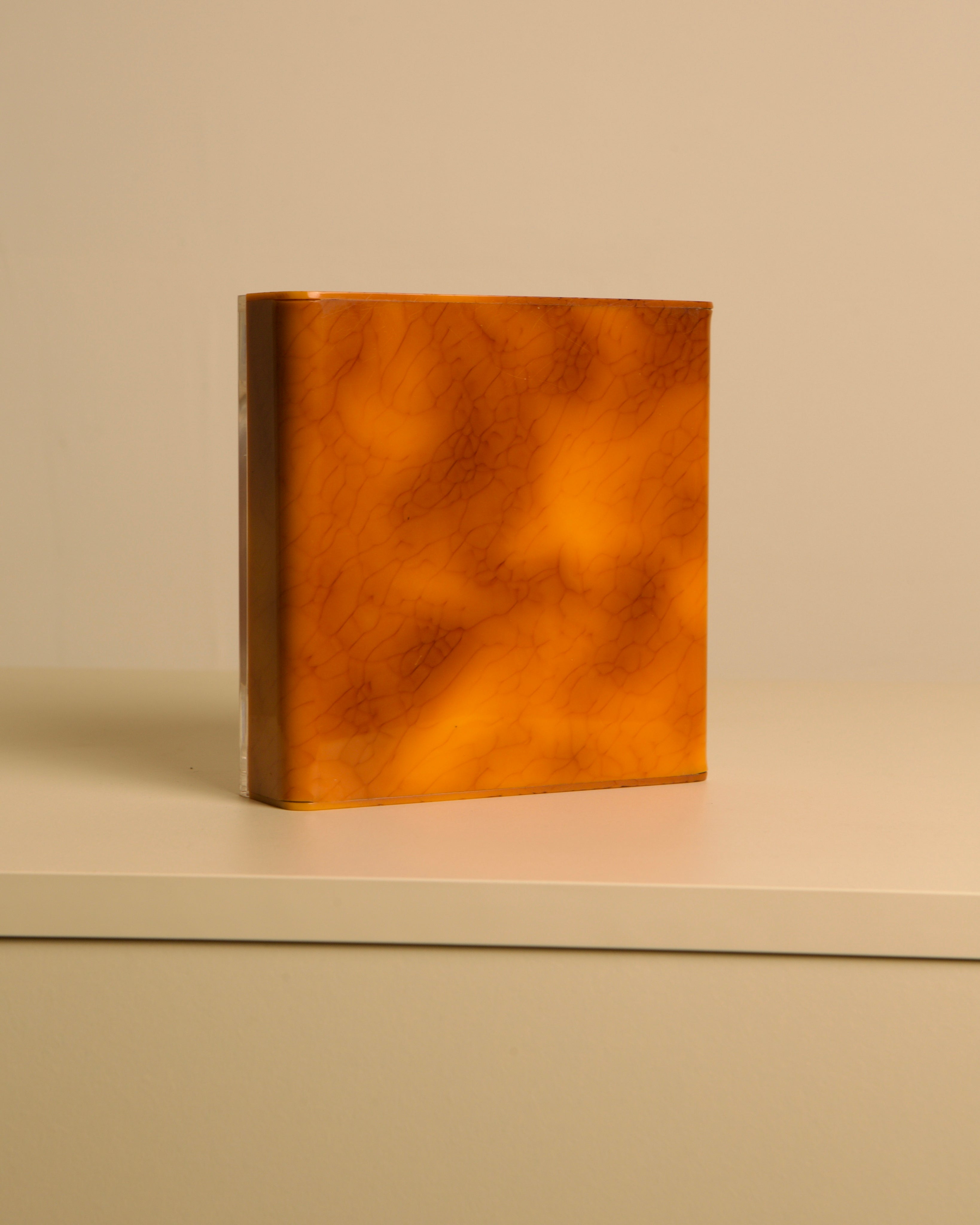 Italian 70s plexiglass and brown bakelite valet tray — top view on neutral background