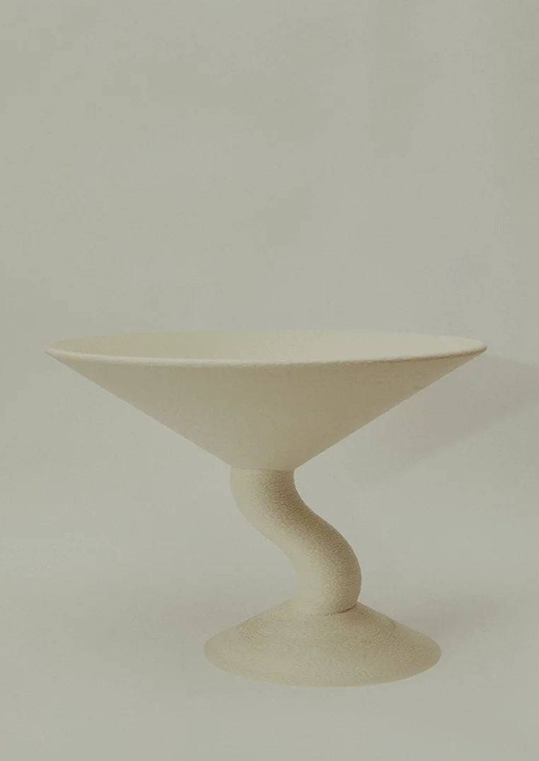 Wavy Fruit Stand — angled view of cream-colored ceramic dish