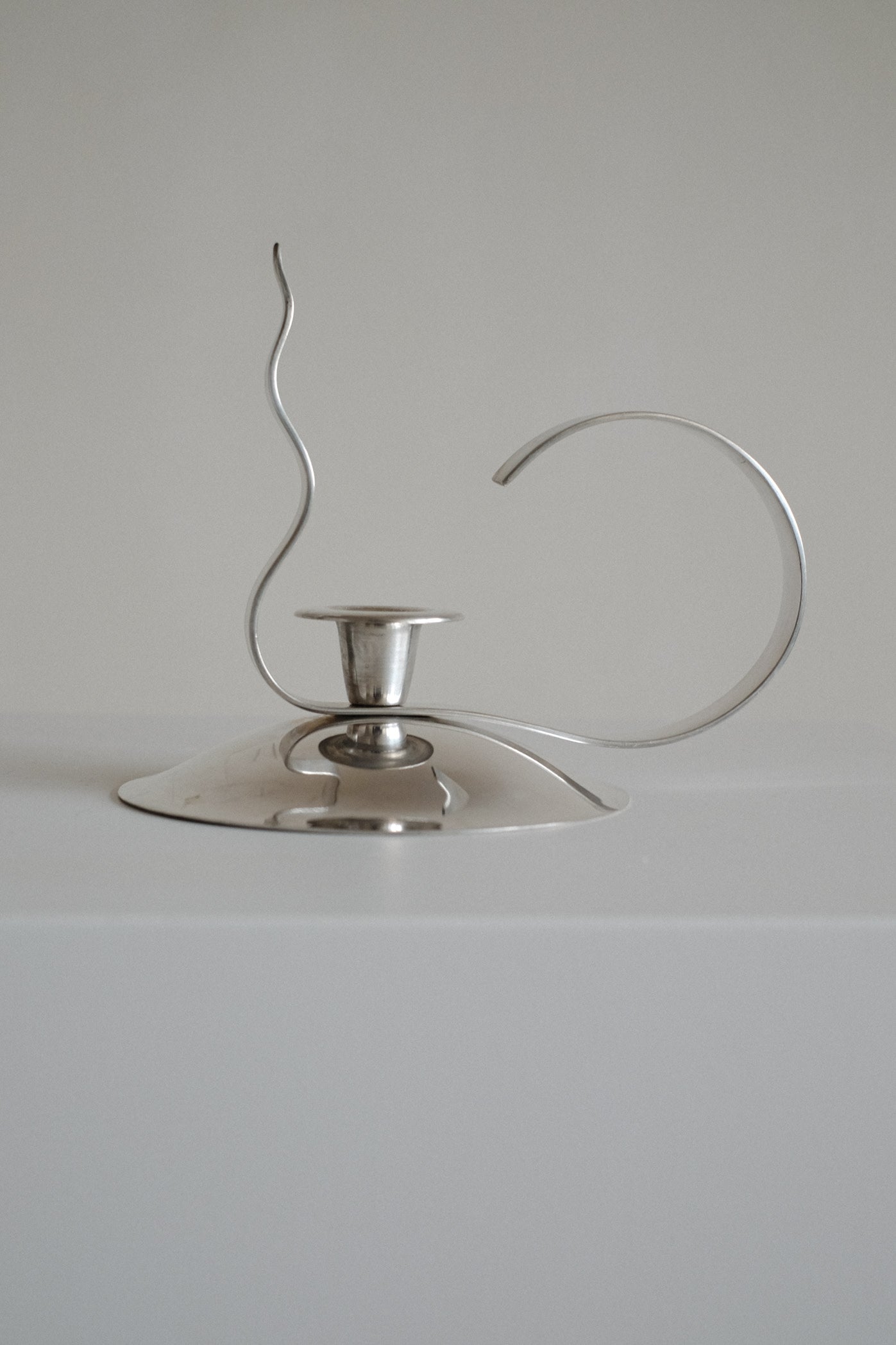 Silver-Plated Candle Holder — angled view highlighting curved design and shine