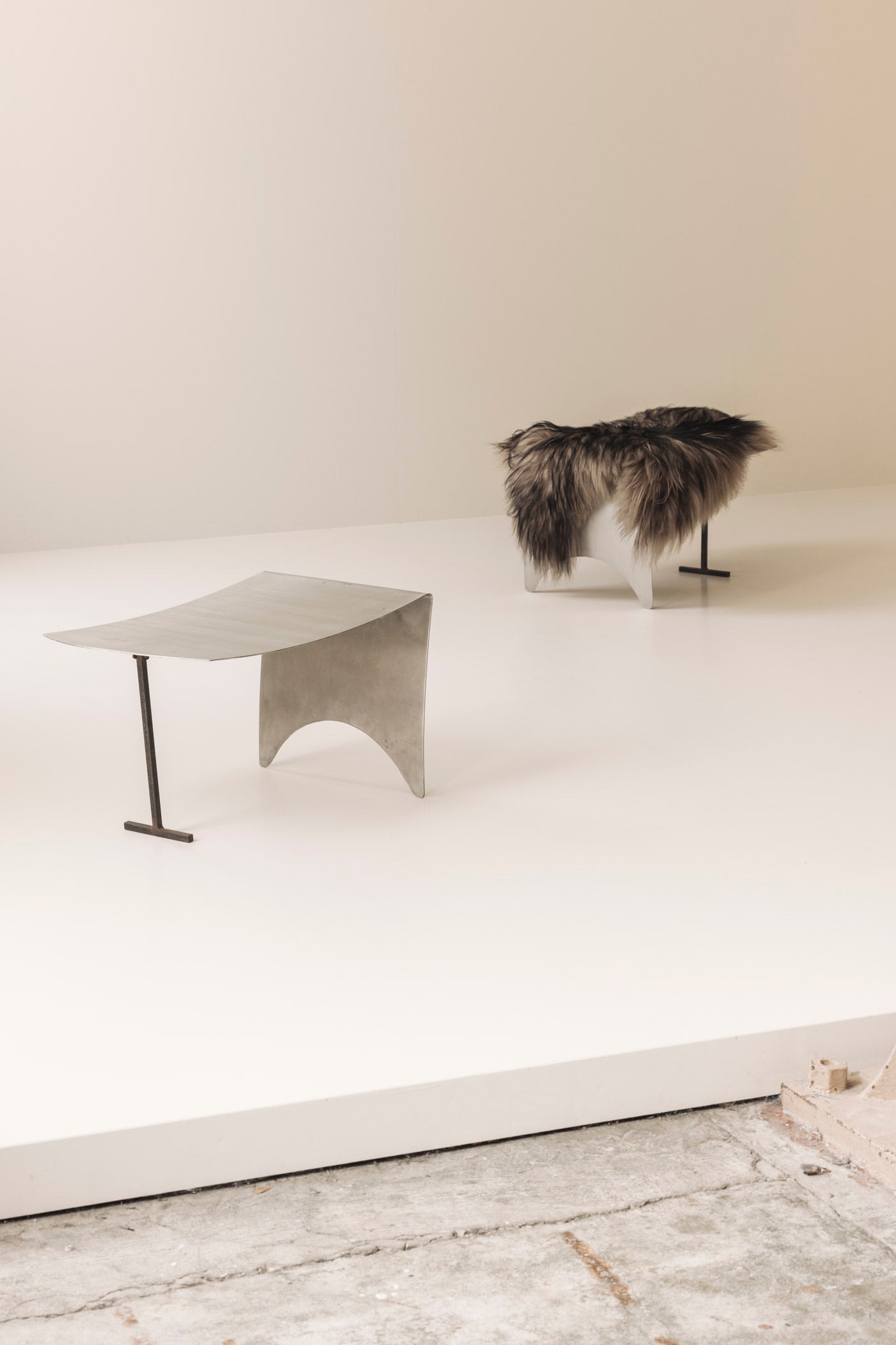 A striking set Modernist curved metal stools from France, dating to the 1980s. — side angle