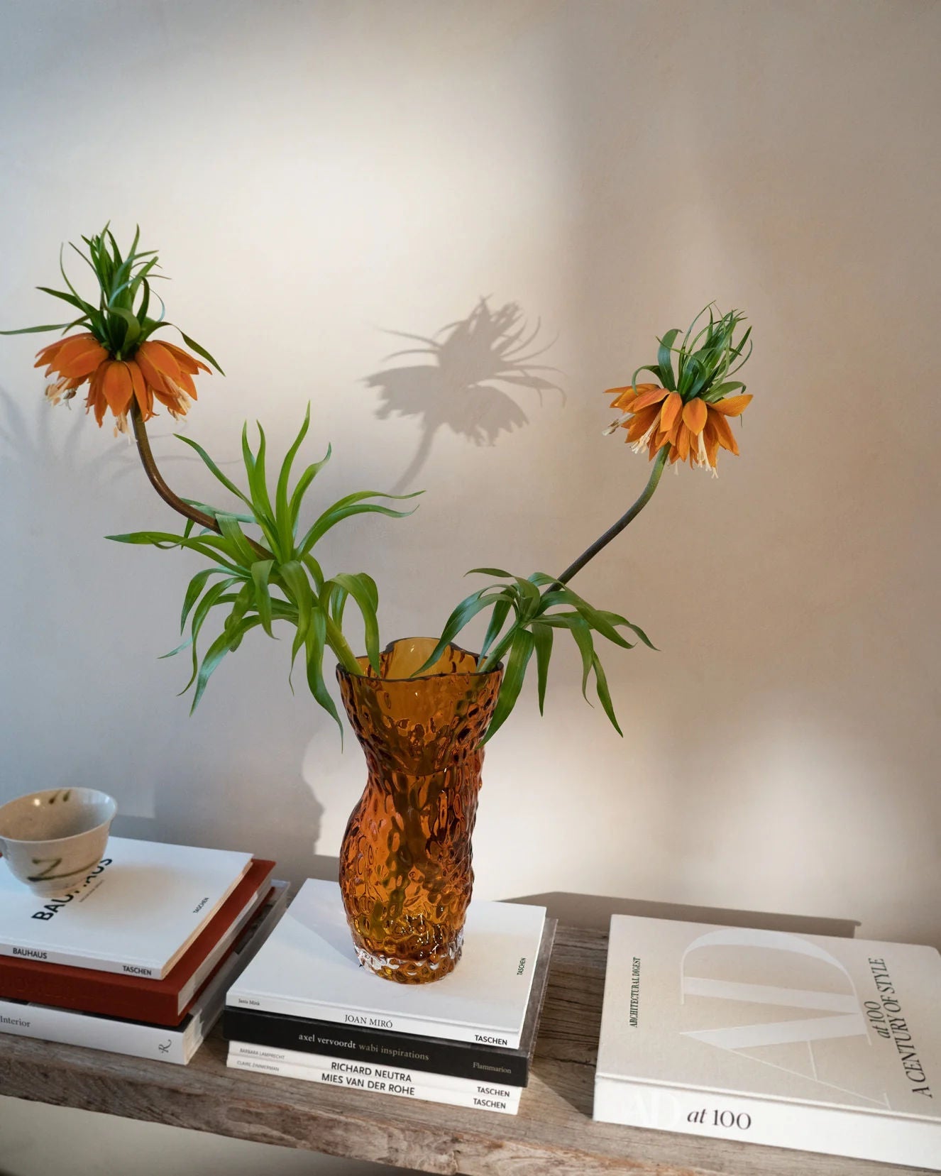 Ostrea Rock Glass Vase - Amber — back view with flowers on wooden shelf