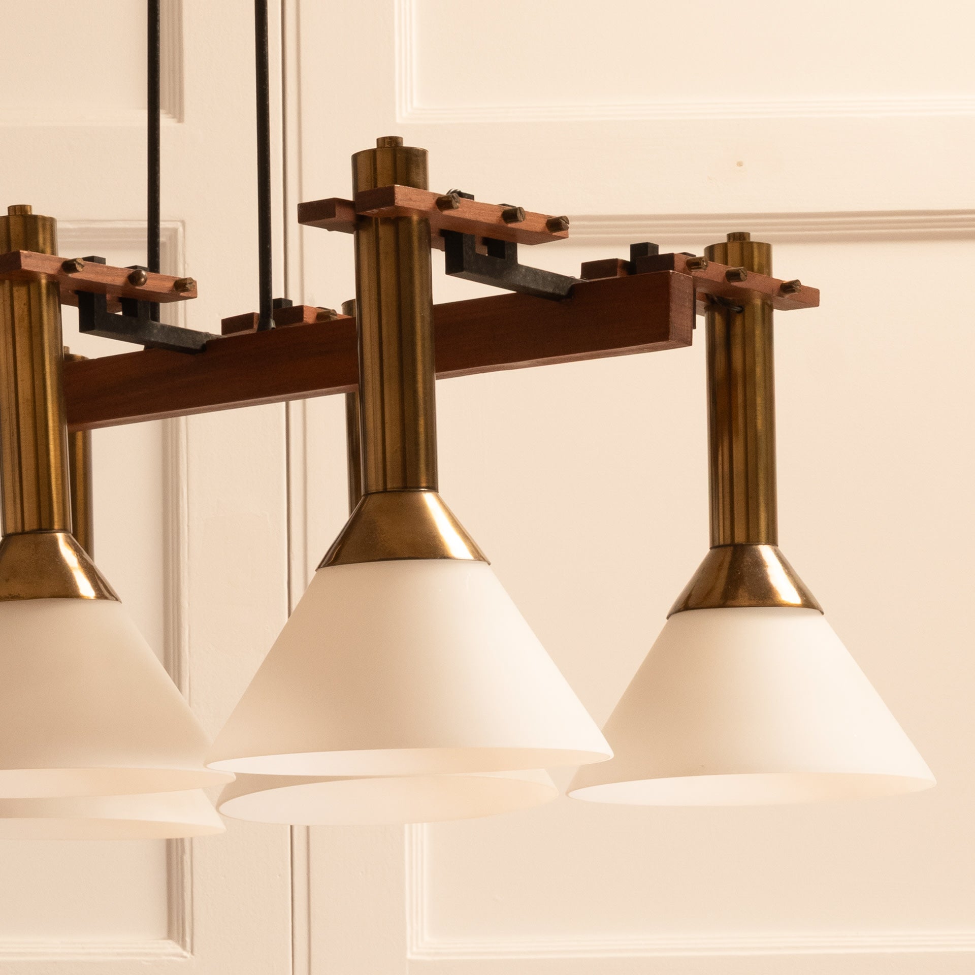 Six-light pendant lamp — close-up of brass and frosted glass shades
